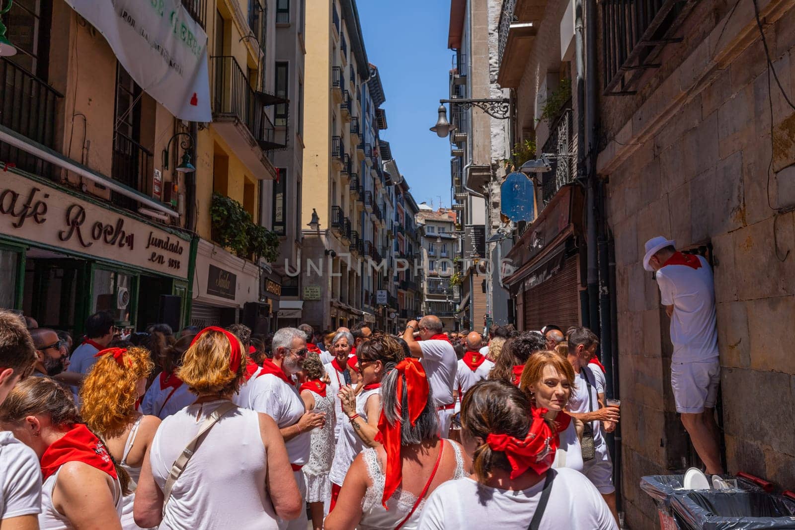 Pamplona, Spain: 09 July 2023: People celebrate San Fermin festival in traditional white abd red clothing with red necktie, Pamplona, Navarra, Spain.