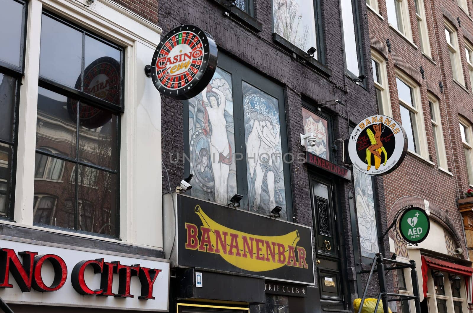 Amsterdam, Netherlands - April 21, 2023: Strip club with live sex shows in De Wallen called the red light district famous for its entertainment character: brothels, coffee shops, pubs and restaurants