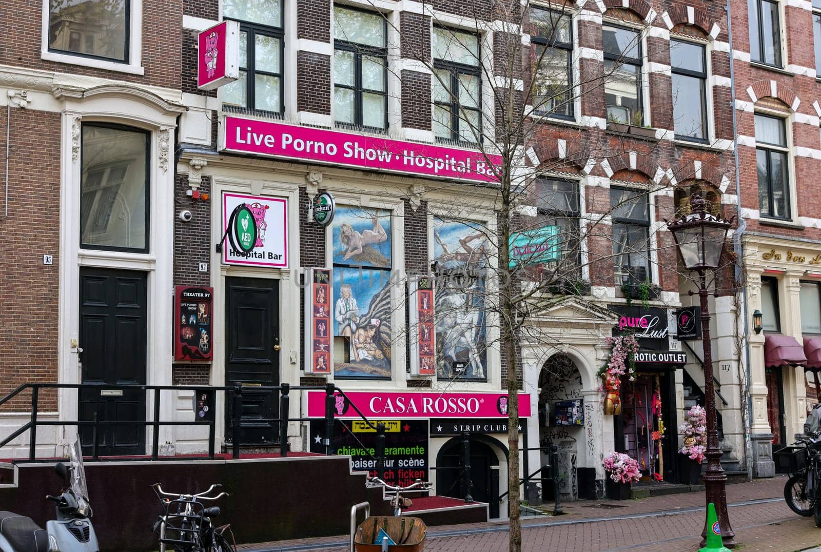 Amsterdam, Netherlands - April 21, 2023: Strip club with live sex shows in De Wallen called the red light district famous for its entertainment character: brothels, coffee shops, pubs and restaurants