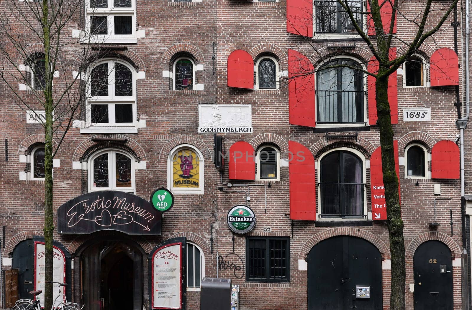 Amsterdam, Netherlands - April 21, 2023: De Wallen - called the red light district. It is famous for its entertainment character: brothers, coffee shops, pubs and restaurants located along the canals