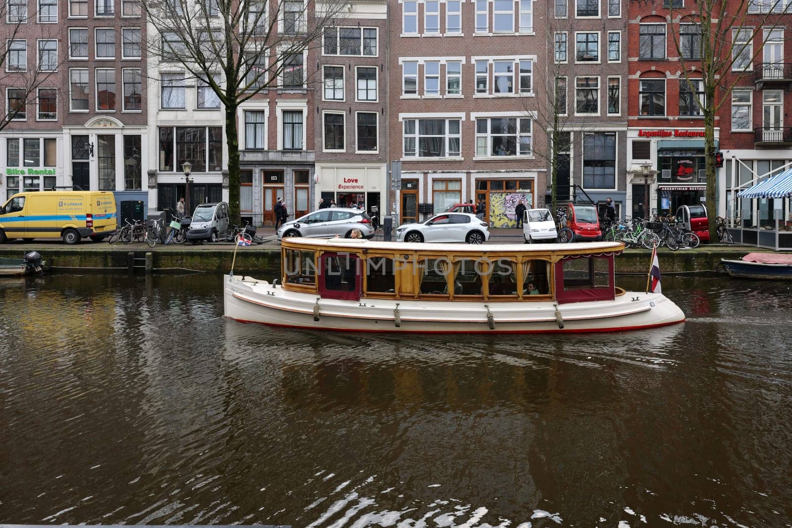 Amsterdam, Netherlands - April 21, 2023: De Wallen - called the red light district. It is famous for its entertainment character: brothers, coffee shops, pubs and restaurants located along the canals