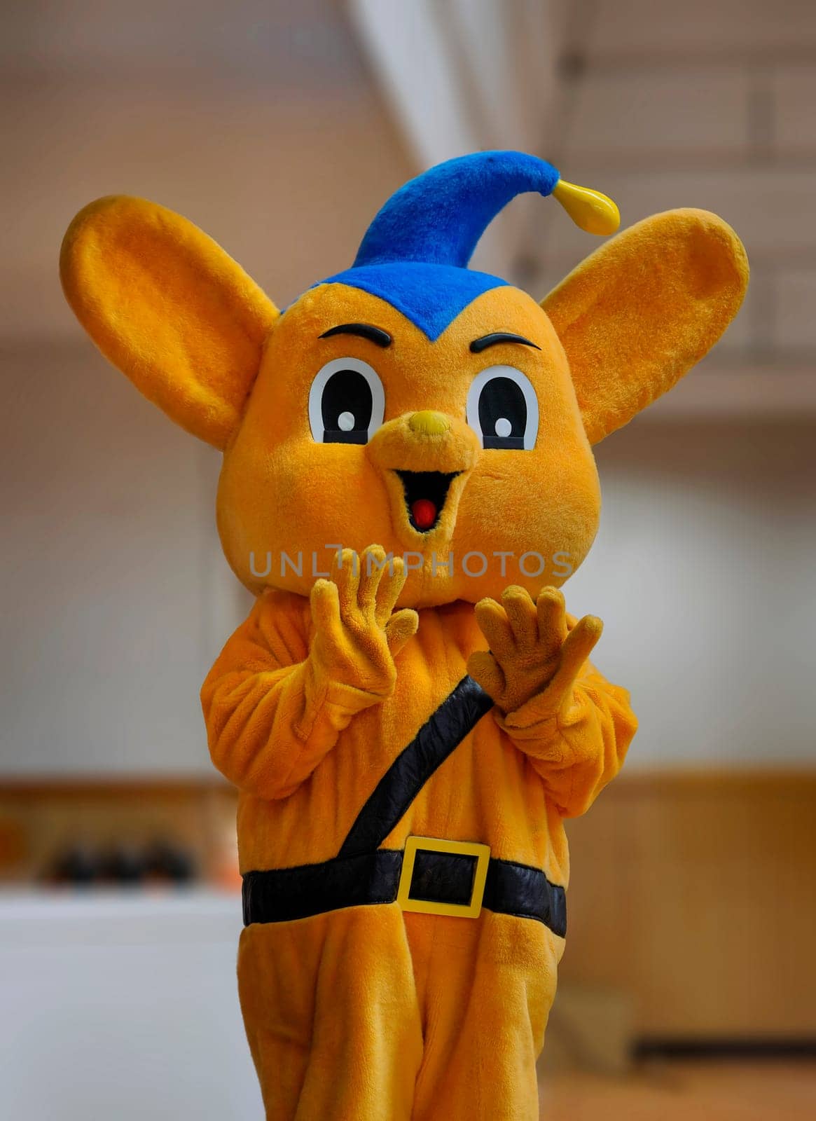 tokyo, japan - mar 31 2023: Orange plush costume of Pipo-kun meaning "PEOple"" and """"POlice"", the official mascot of the Japanese Metropolitan Police Department since 1987 waving hands to camera."