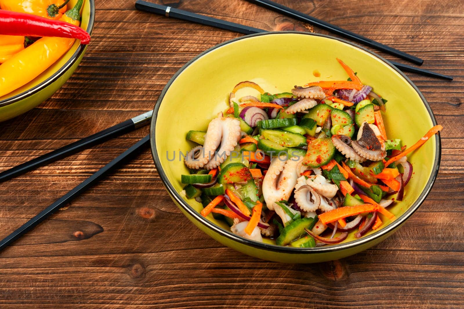 Salad of squid, cucumber, onion and octopus. Korean cuisine with seafood