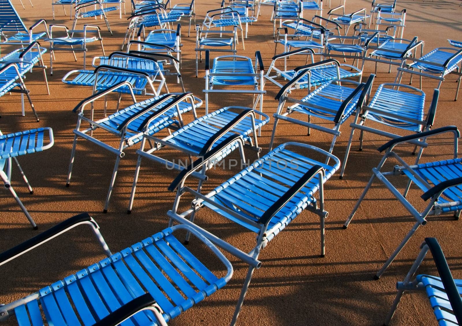 benches with plastic seat covers in blue at the deck of the ship in harmonic order