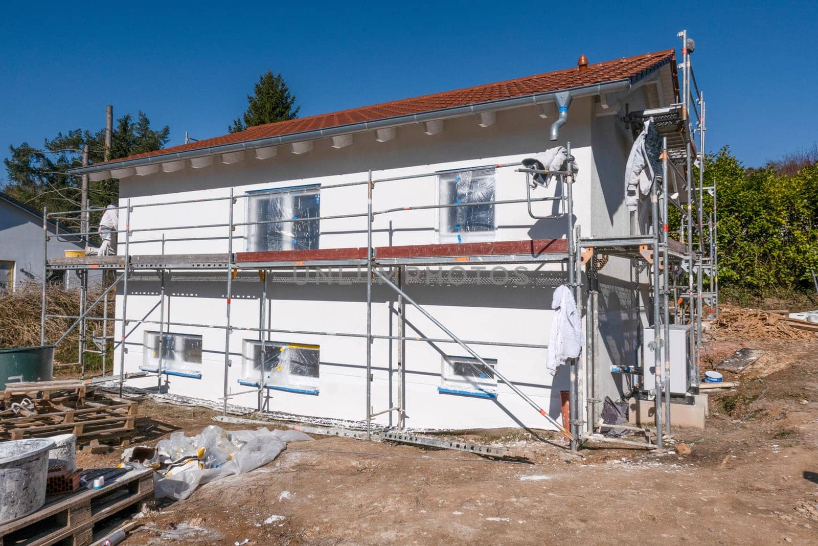 worker are preparing the insulation of the facade with modern coldness resistance building material at the construction site