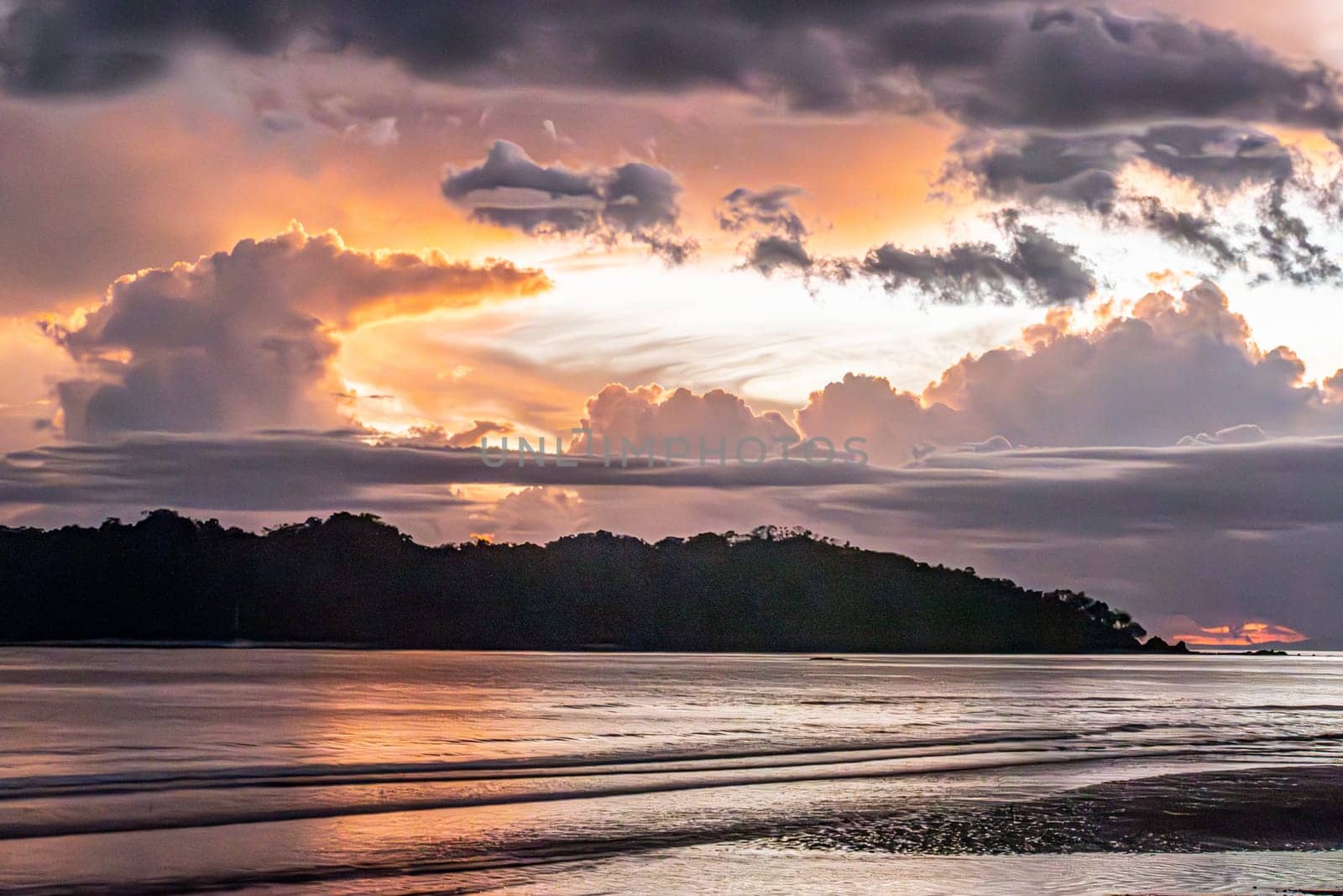 romantic sunset in intensive colors at the ocean with bright clouds at Santa Catalina, Panama