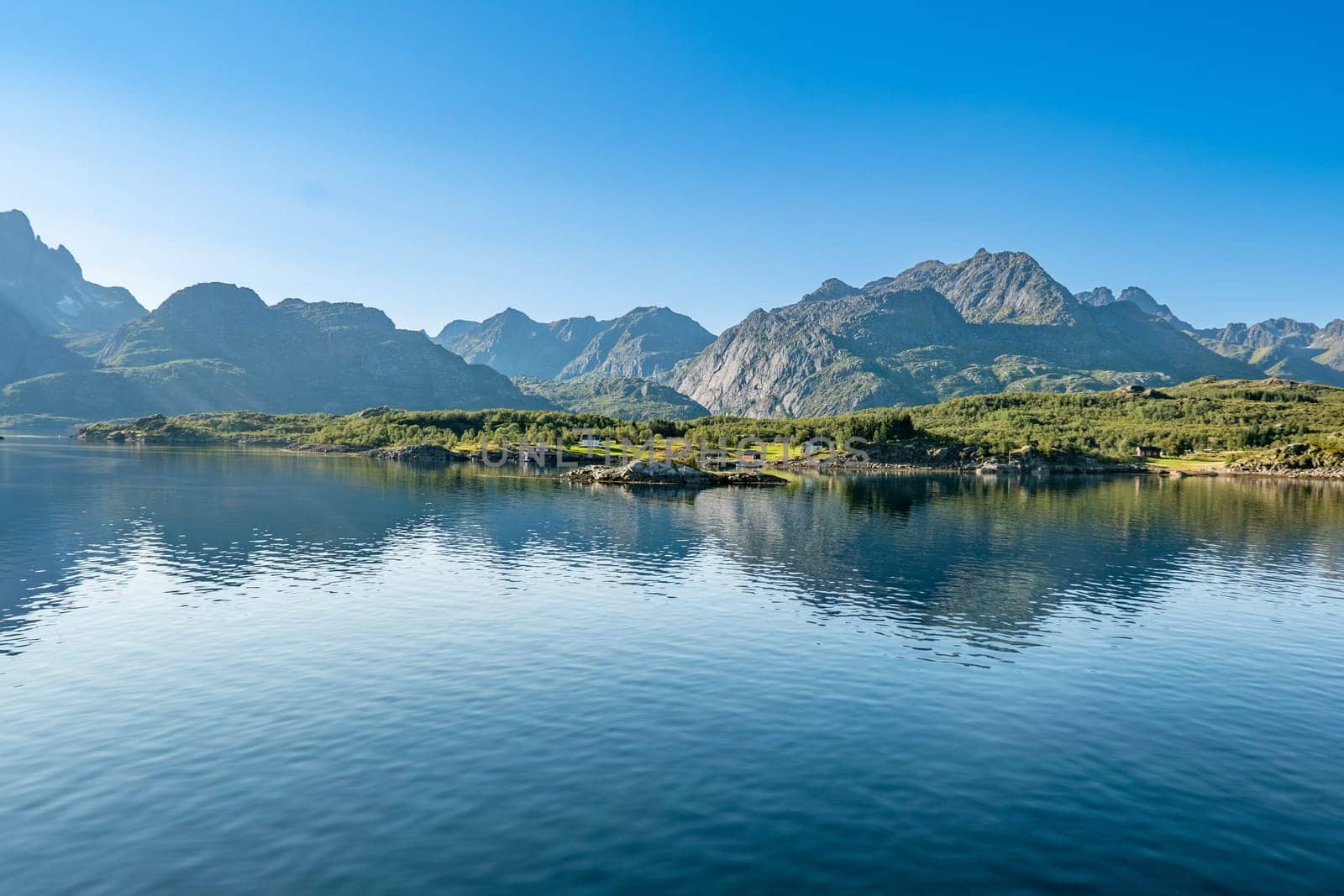scenic view to the entrance of the Trollfjord with reflection in the ocean in Norway