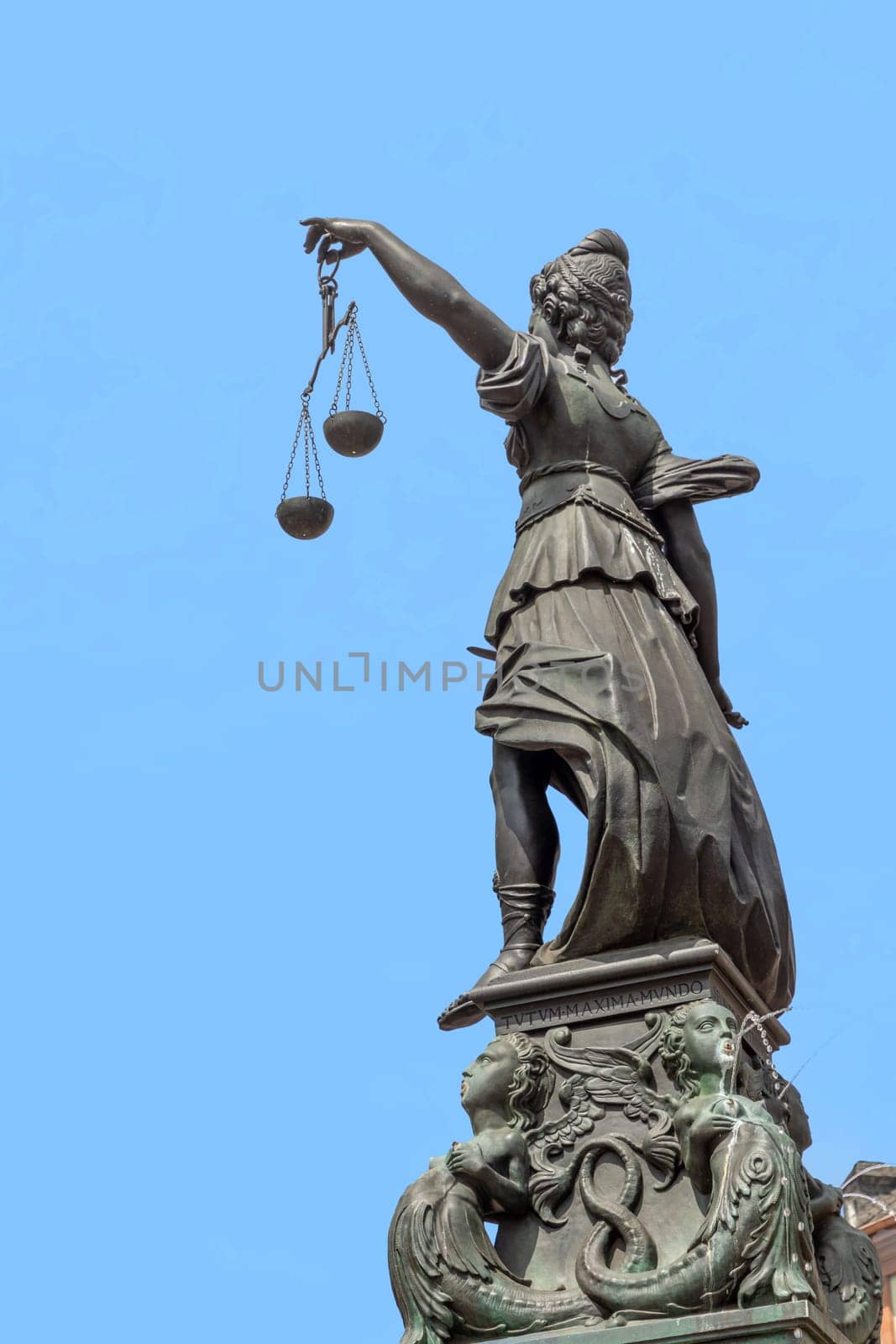lady justice with sword and balance wage in Frankfurt under blue sky