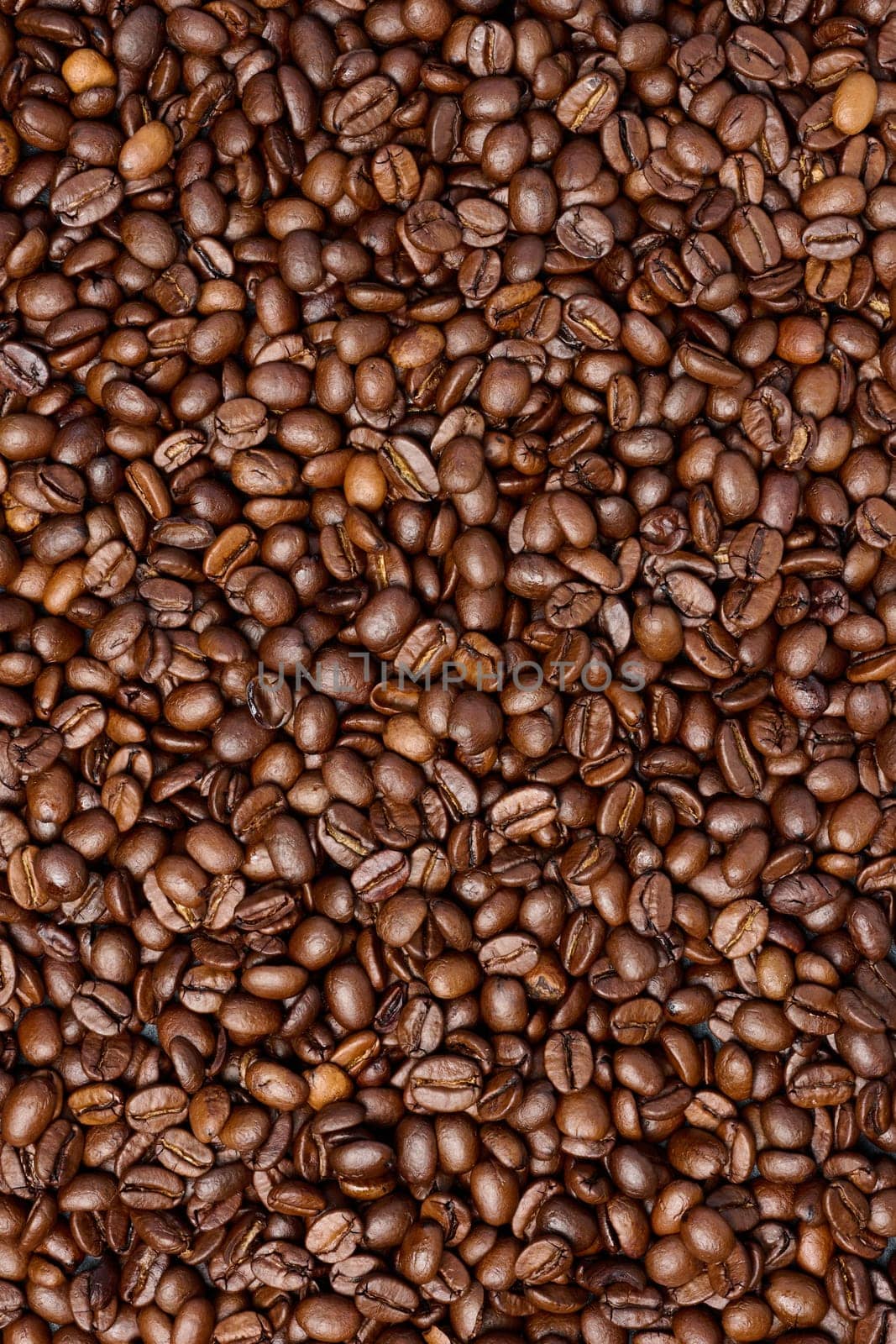 Scattered roasted coffee beans, full frame