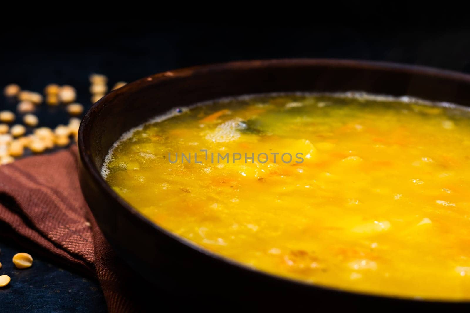 Homemade healthy vegetable soup with some bread and an onion