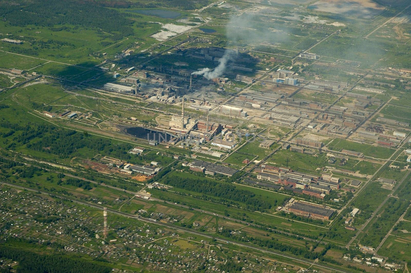 Top view of the industrial center of the city, factories and smoke pipes.