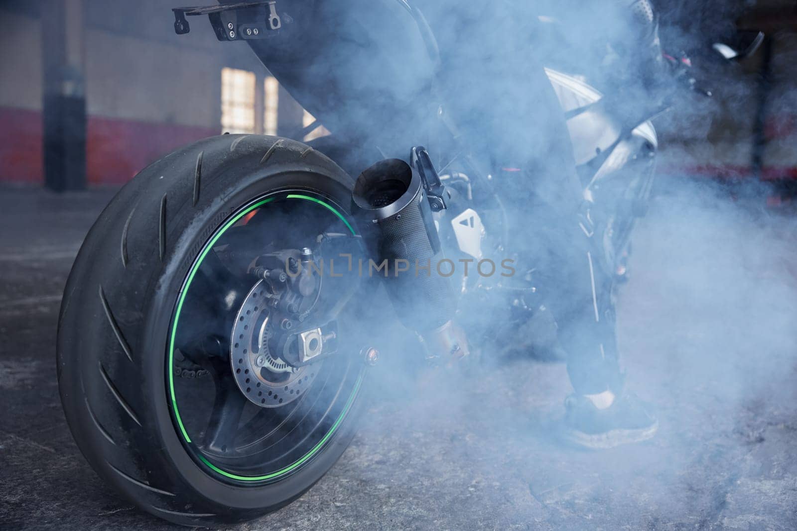 Motorcyclist squeezing clutch to start training race at motordrome. Driving school professional occupation