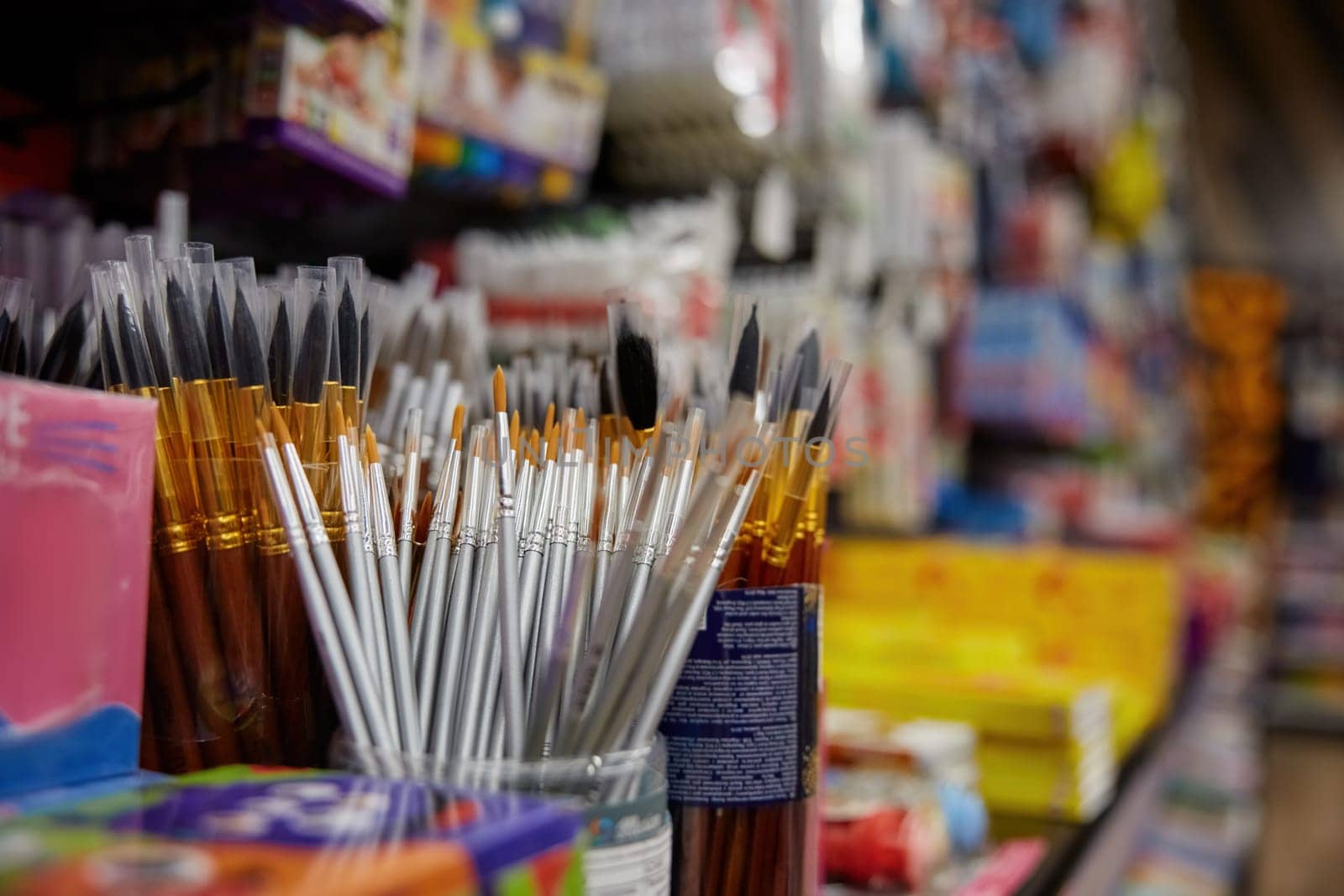 Paint brush assortment on display of creative stationery store. Artist tool with synthetic and natural bristles on sale