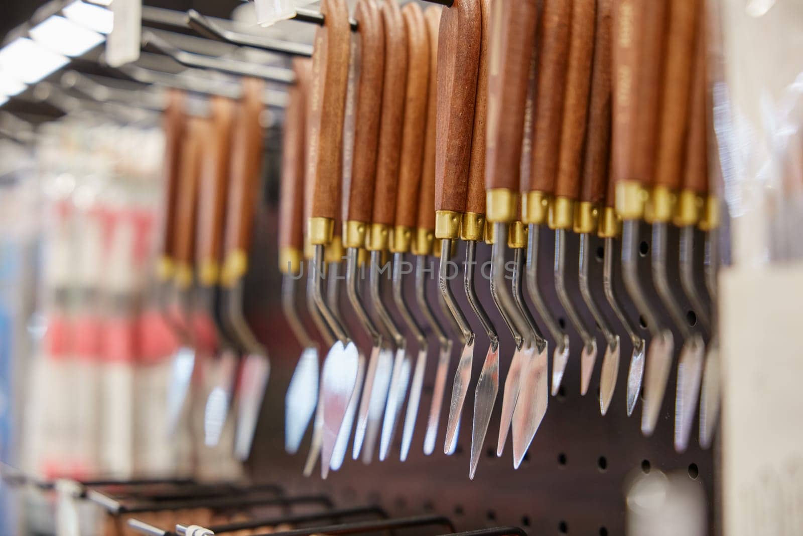 Selective focus with trowel or palette knife for drawing. Artistic tools showcase assortment at art stationery shop