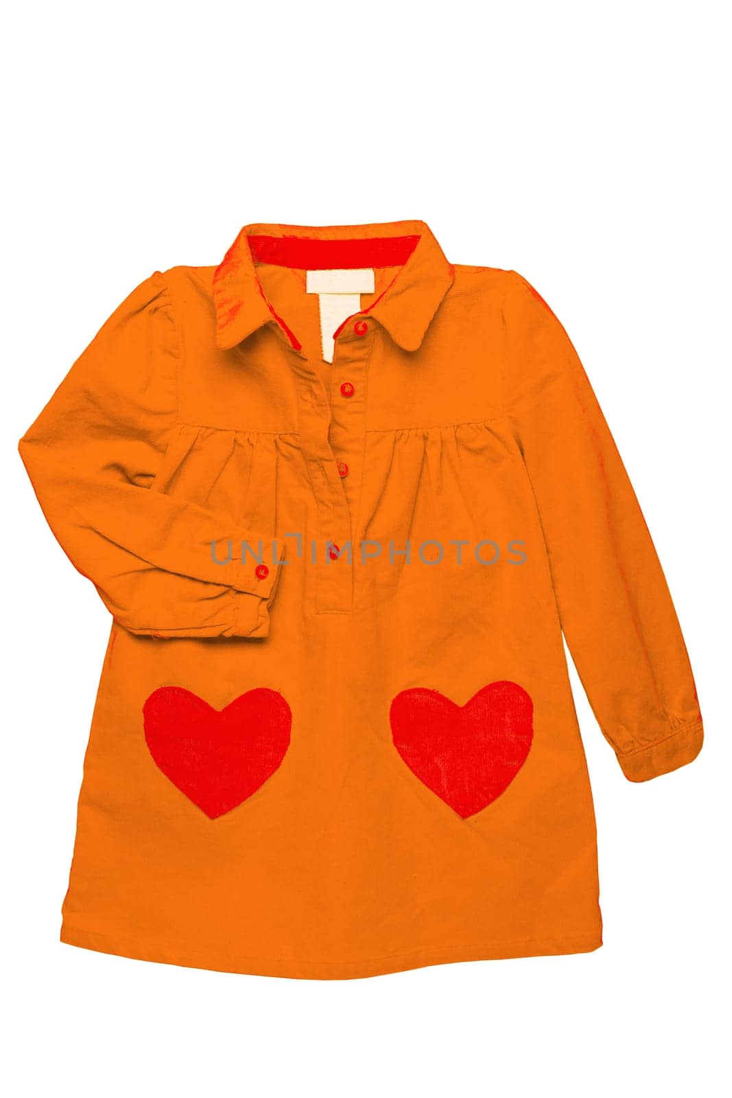 Summer dress isolated. A beautiful orange girls dress with attached heart shaped pockets and long sleeves isolated. Clipping path. Kids spring and autumn fashion.