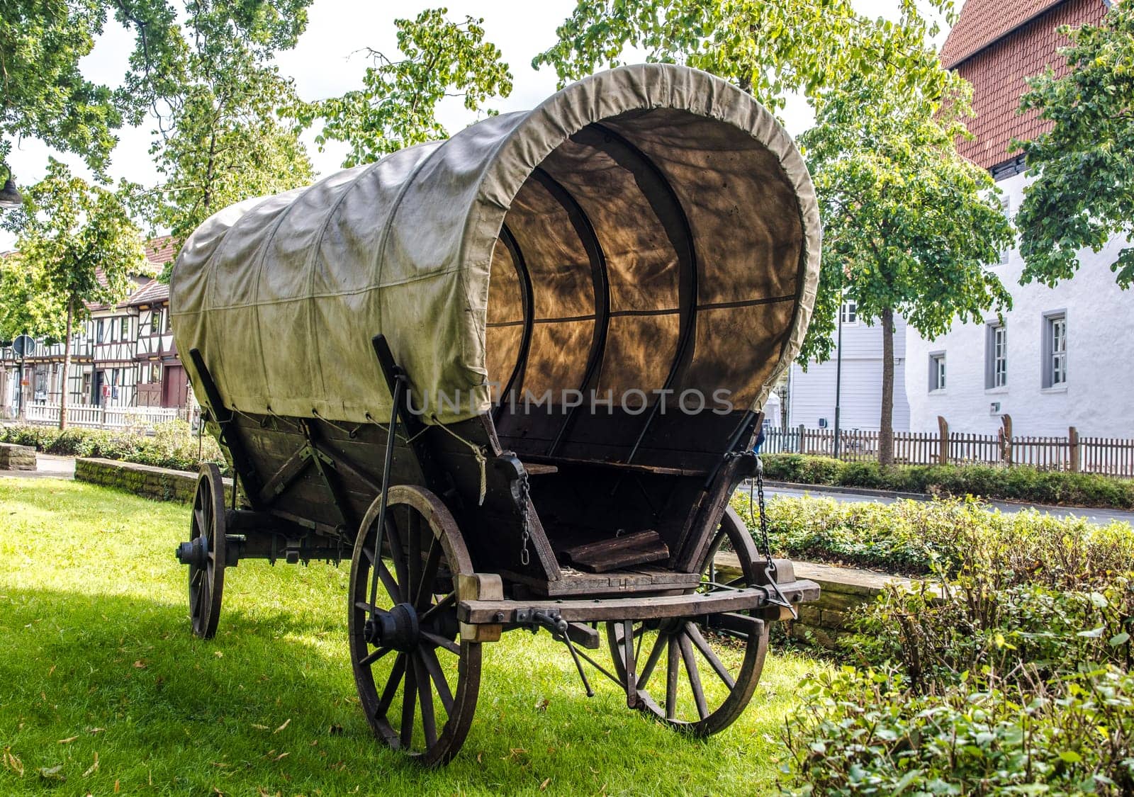 Covered wagon in a public park on a summer day.