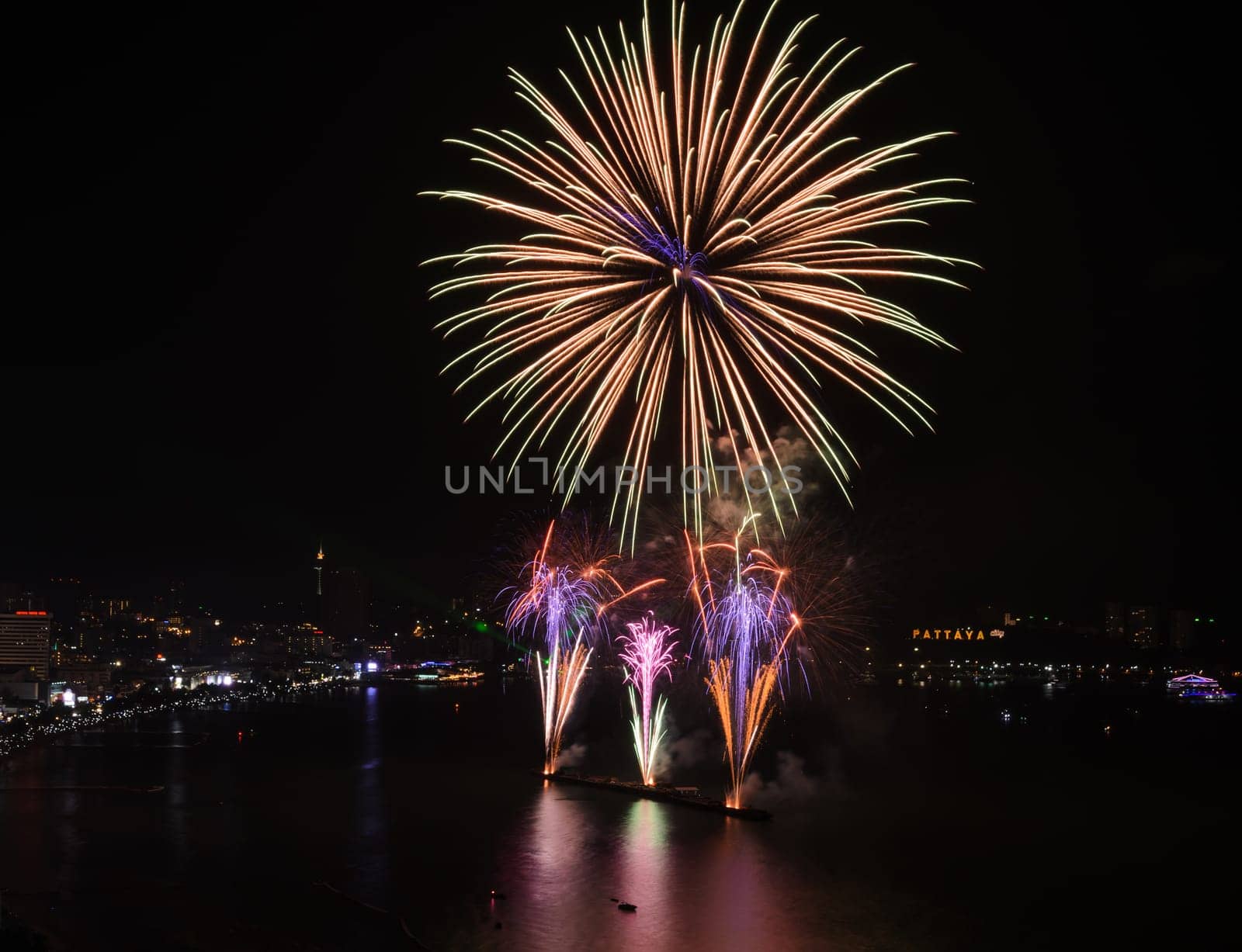 Big firework on the sky at Pattaya coast with cityscape background, Thailand