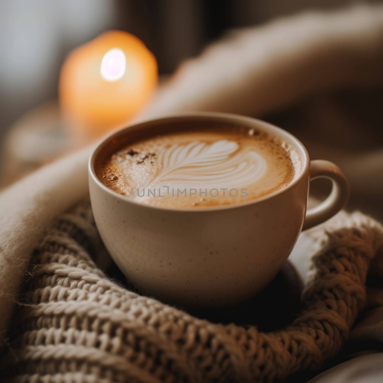 A cozy scene with a cappuccino cup, latte art, soft blankets, and warm candlelight
