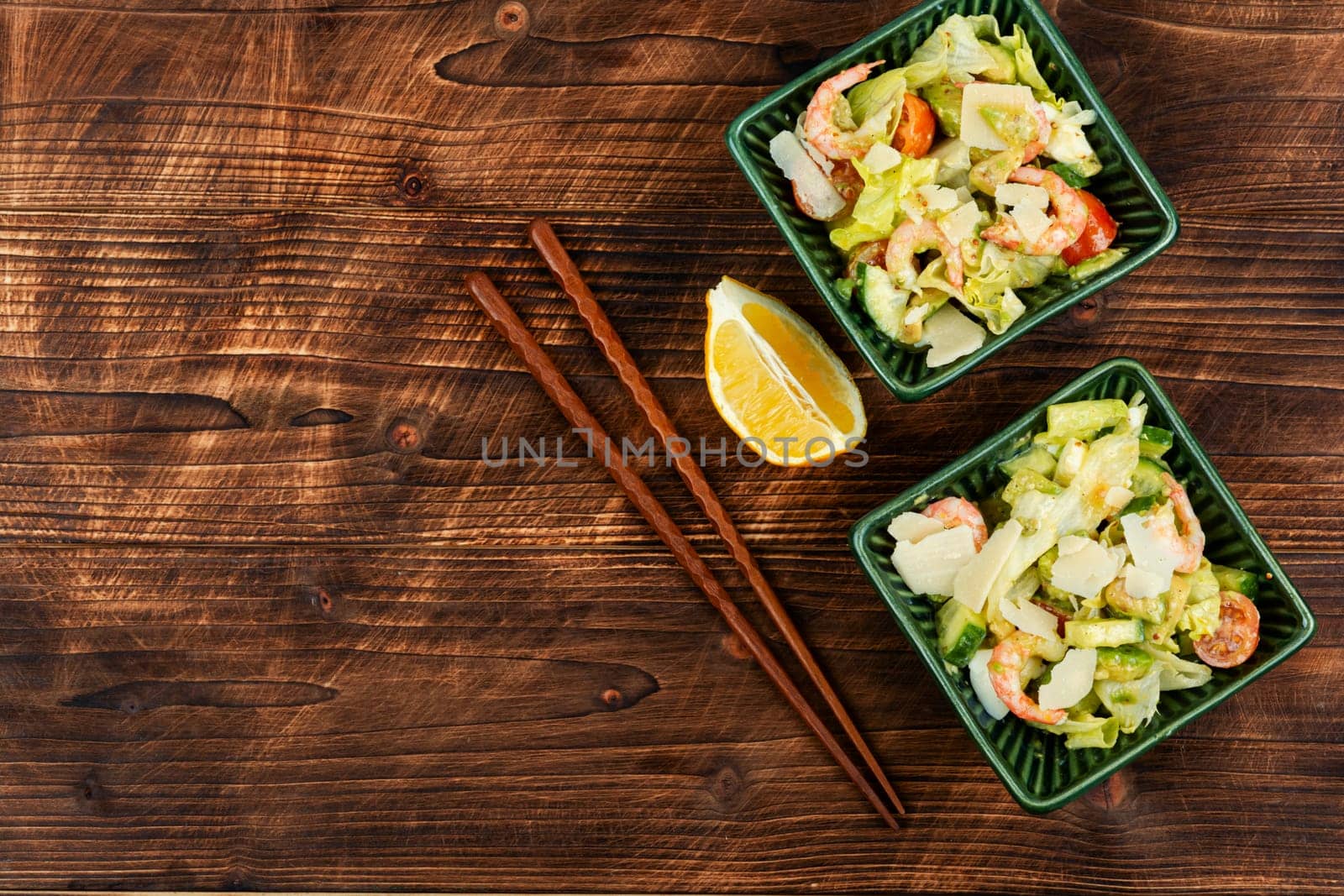 Asian salad with shrimp,prawns and avocado slices on a vintage wooden background. Healthy eating. Space for text.