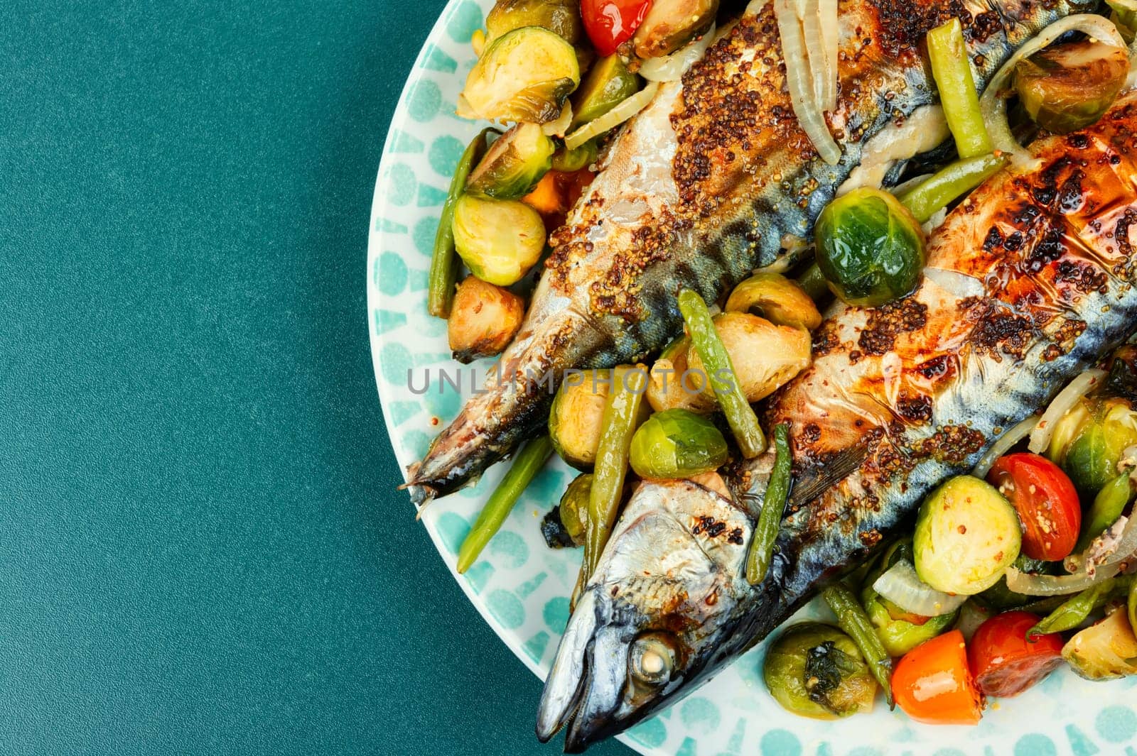 Baked mackerel fish and tomatoes, cabbage and green beans. Tasty fish, seafood.