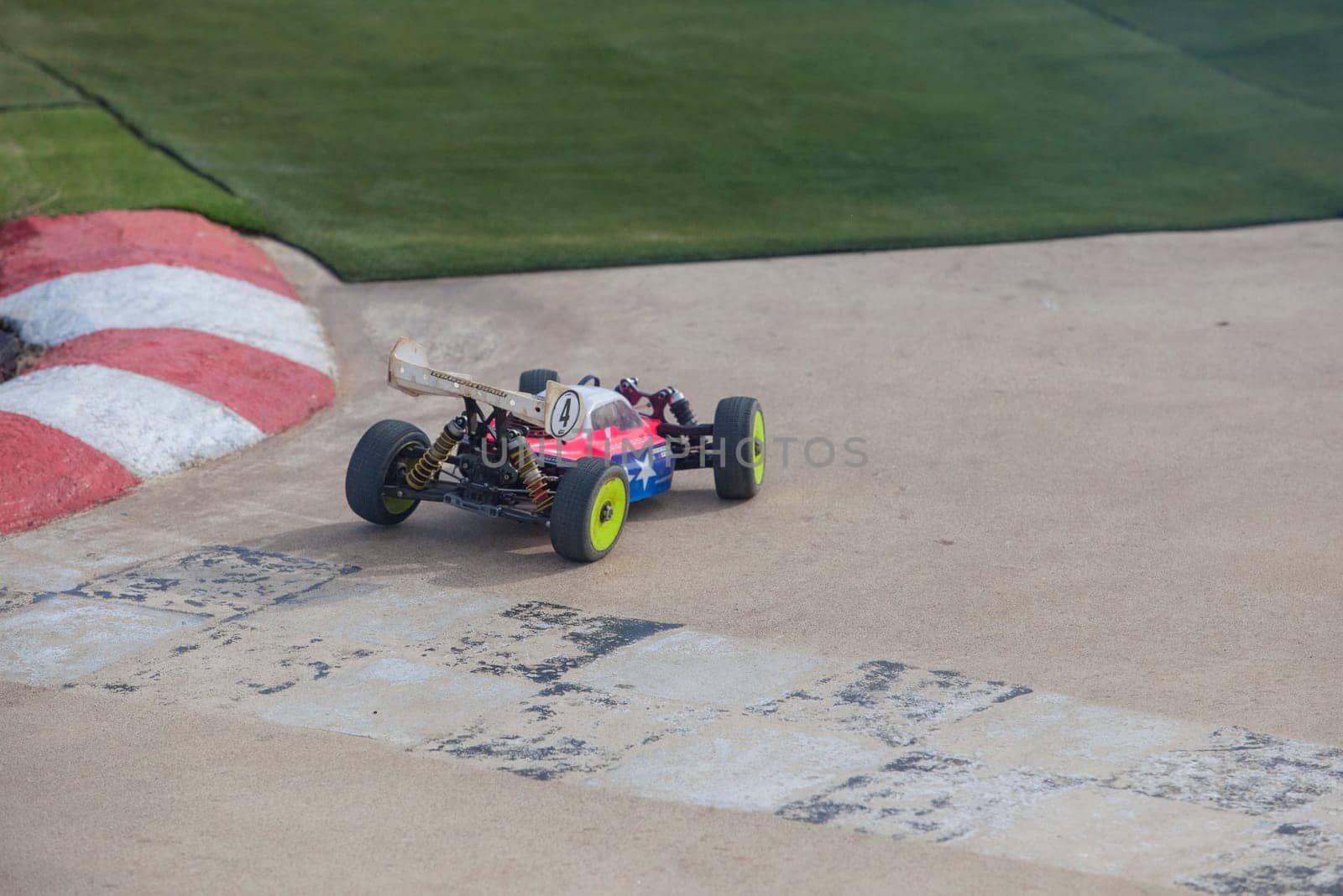 Merida, Spain - Jan 28th, 2024: Extremadura 1/8tt gas Championship RC Car. Cars making a curve over concrete surface