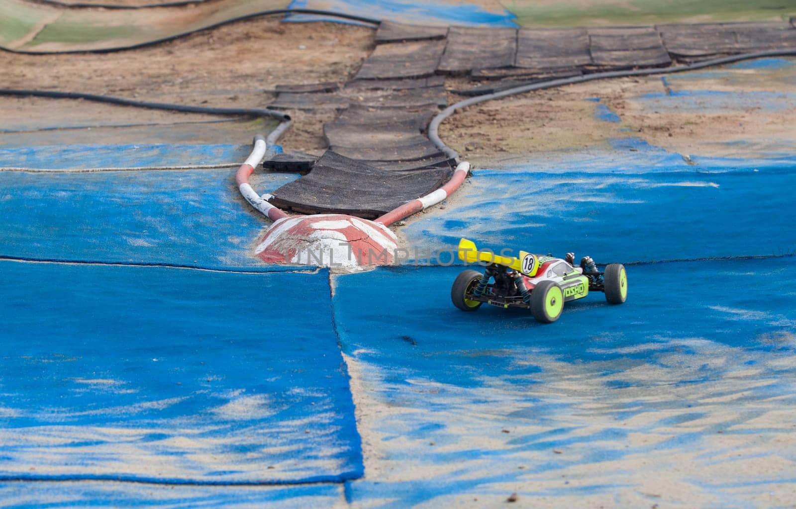 Merida, Spain - Jan 28th, 2024: Extremadura 1/8tt gas Championship RC Car. Cars making a curve over blue turf