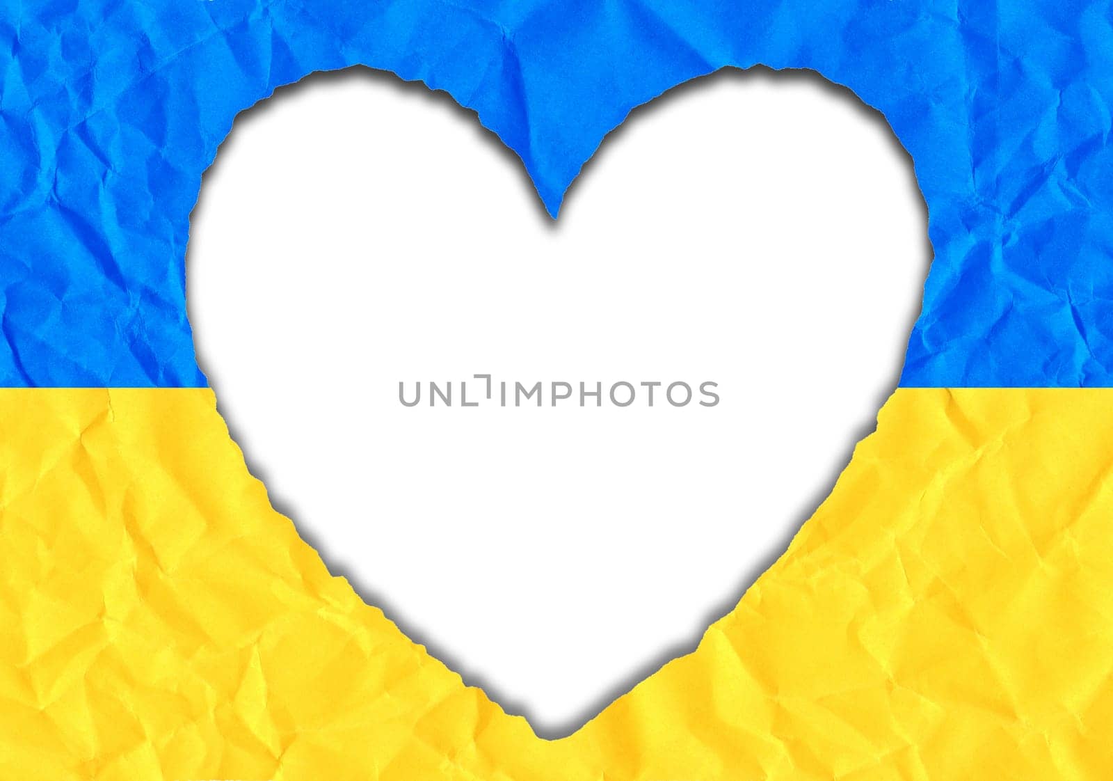 Scrap of paper in the shape of a heart in the colors of the Ukrainian flag, copy space