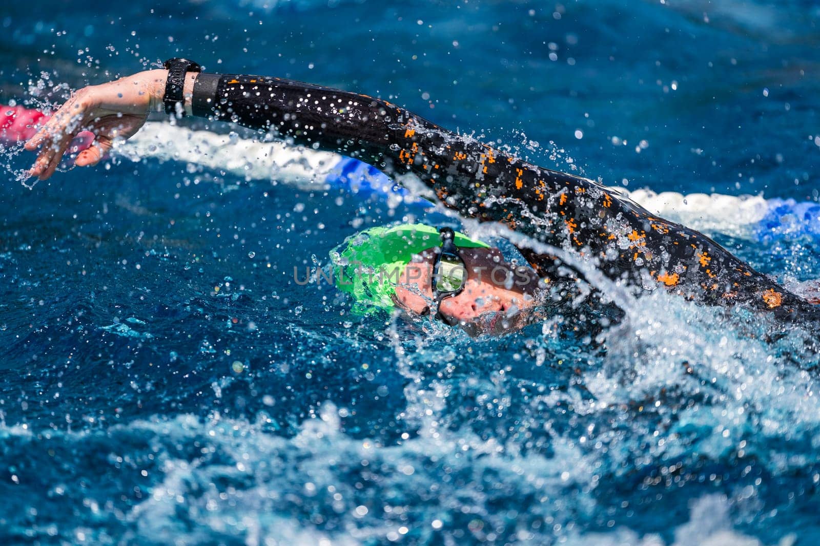 Crawl swimmer in a pool, wearing a wetsuit