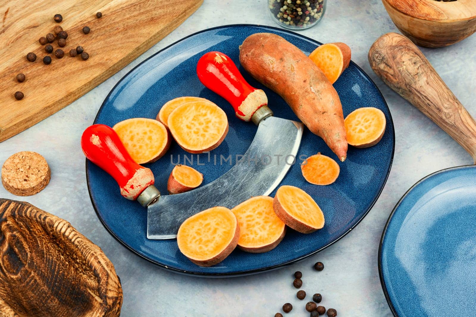 Raw sweet potatoes or batatas. Yam on concrete kitchen table. Dietary food. Space for text.