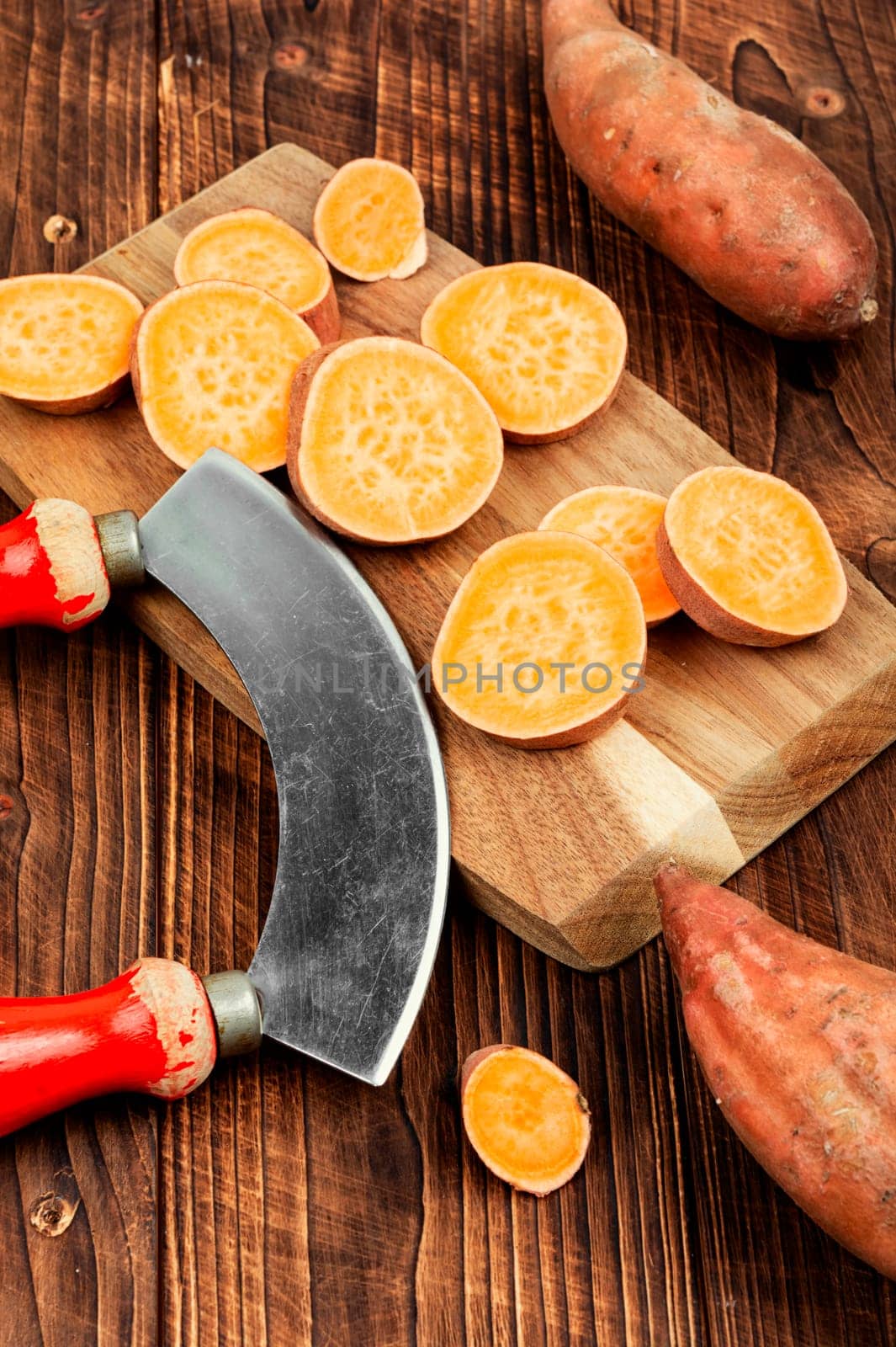 Raw sweet potatoes or batatas. Yam on concrete kitchen table. Dietary food. Space for text.