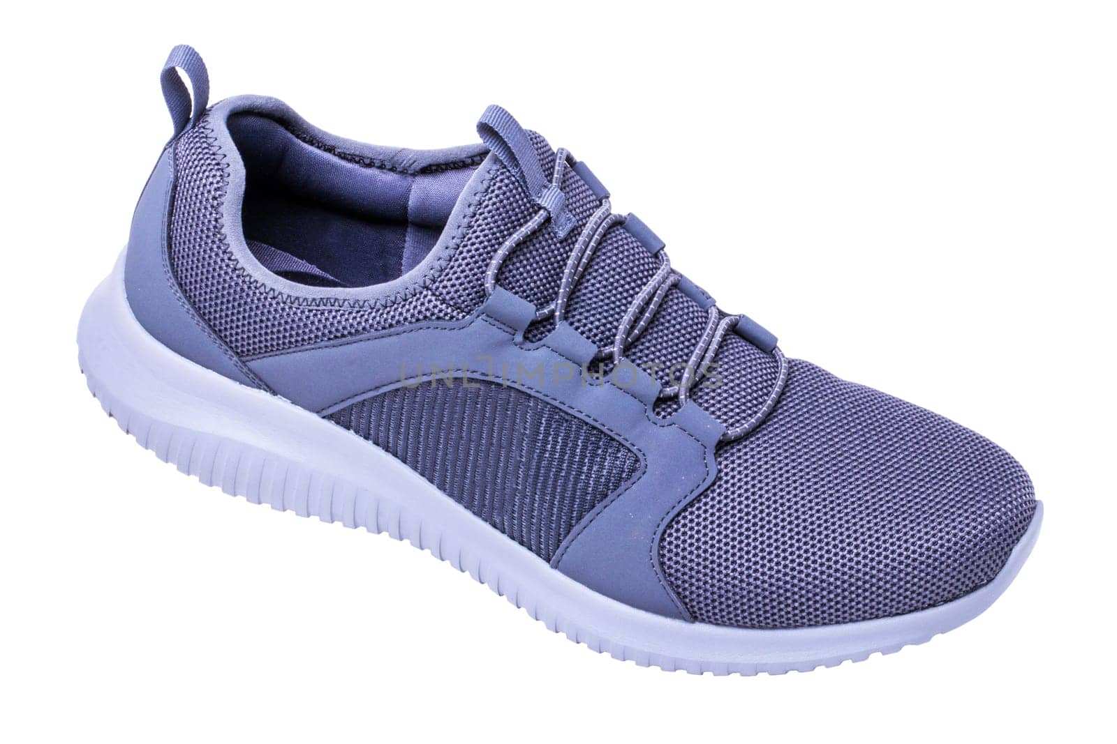Closeup of a pair of modern silver gray sneakers or sports shoes isolated on a white background. Clipping path. Elegant and trendy mans shoes. Macro.