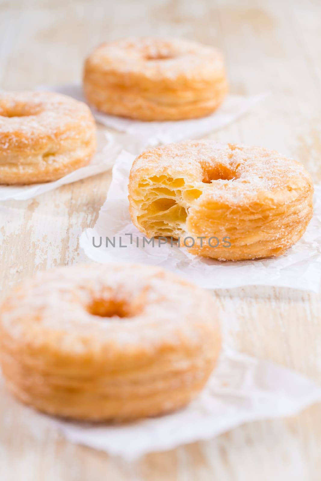 Cronuts - delicious fusion of croissant and donut with raspberry jam. Half-donut and half-croissant pastry