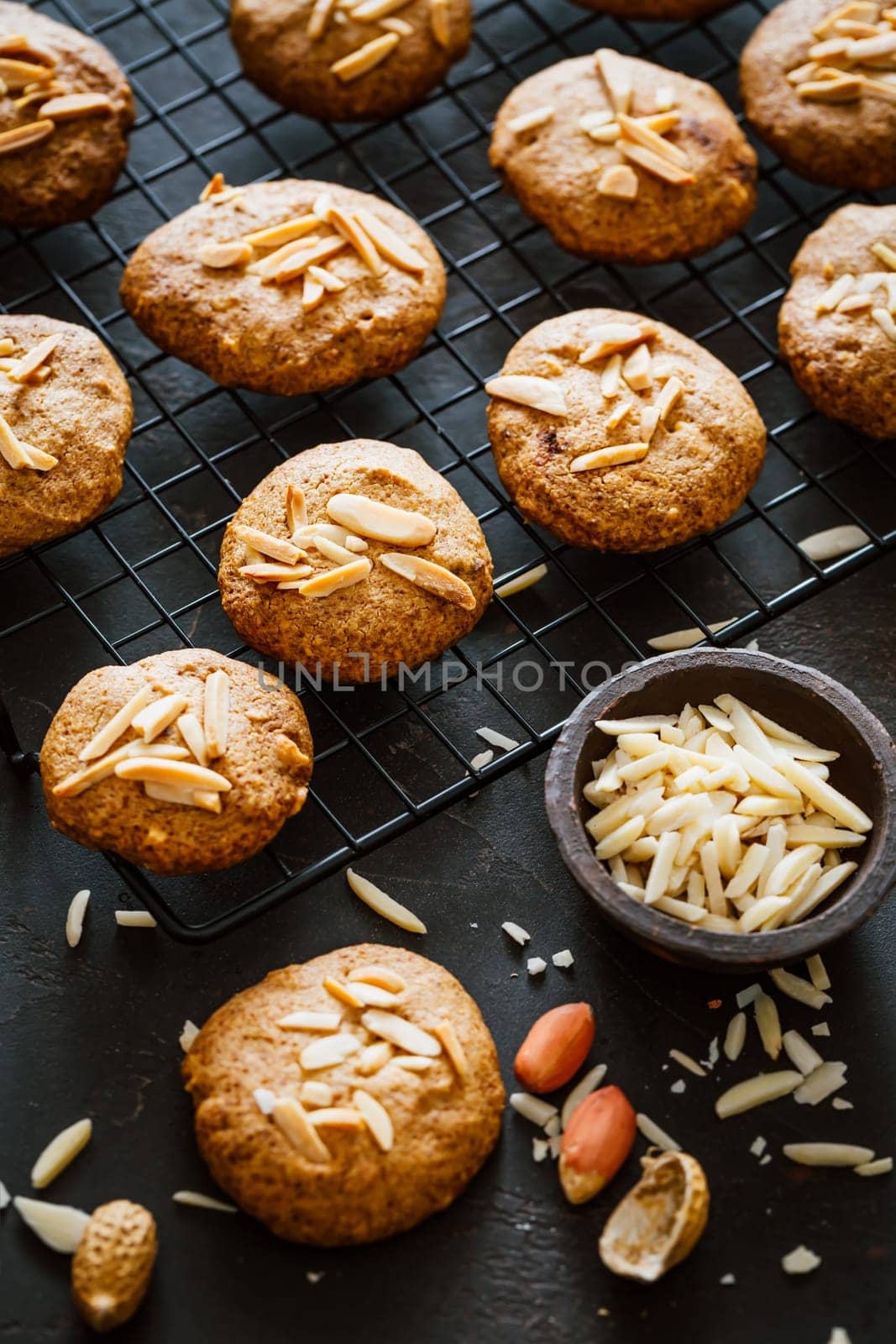 Homemade peanut butter cookies with almond on dark background