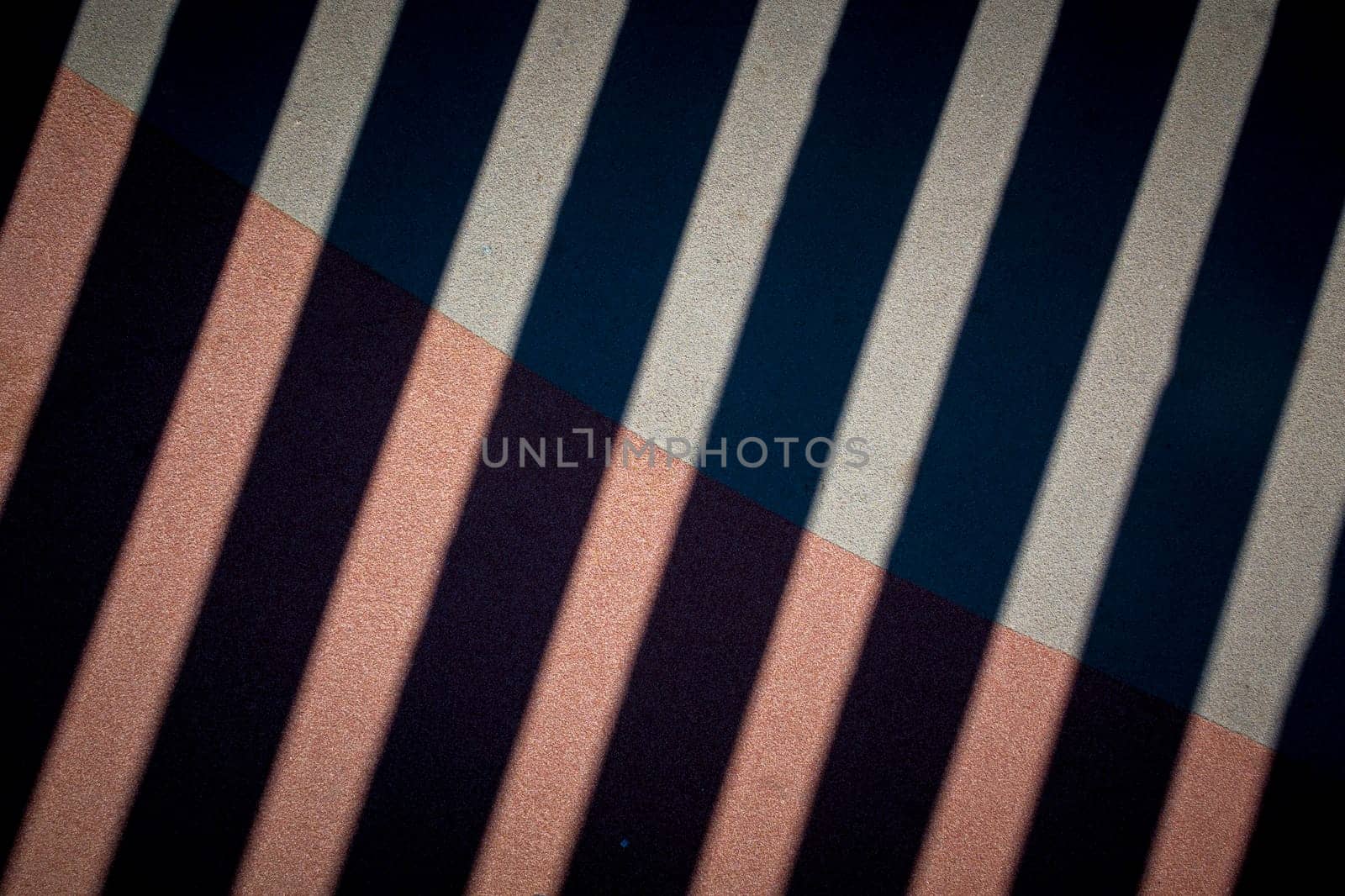 Pattern of diagonal stripes with different colors and textures. The upper part has smooth grey and black stripes, while the lower part has textured pink and purple stripes.