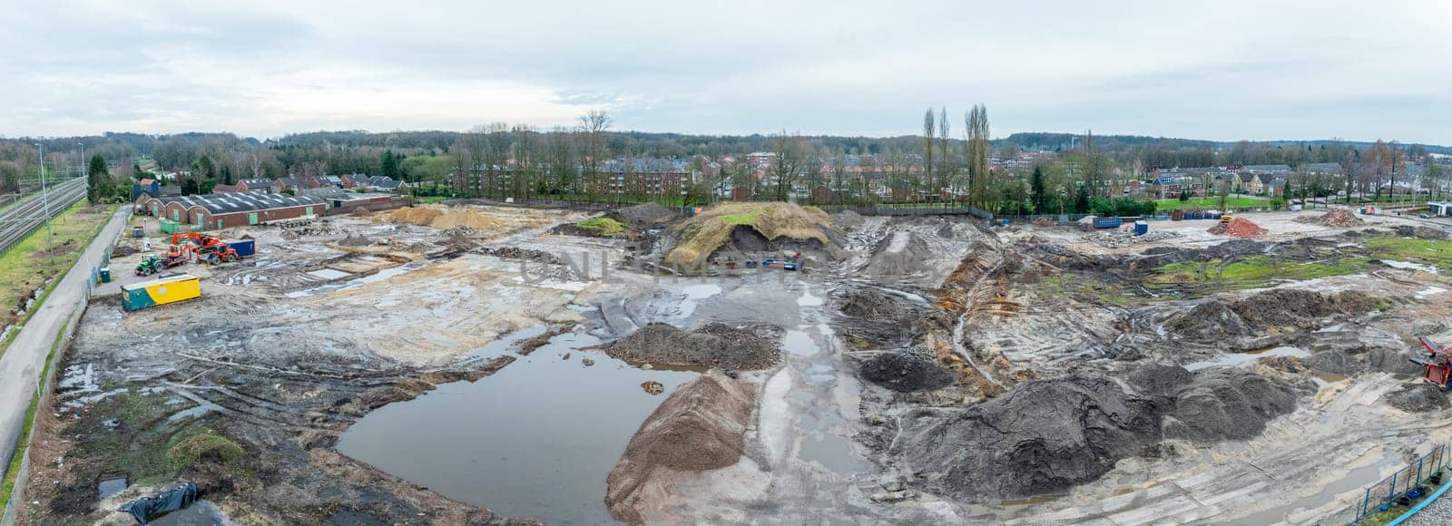 aerial view of a construction site next to a reesidential area