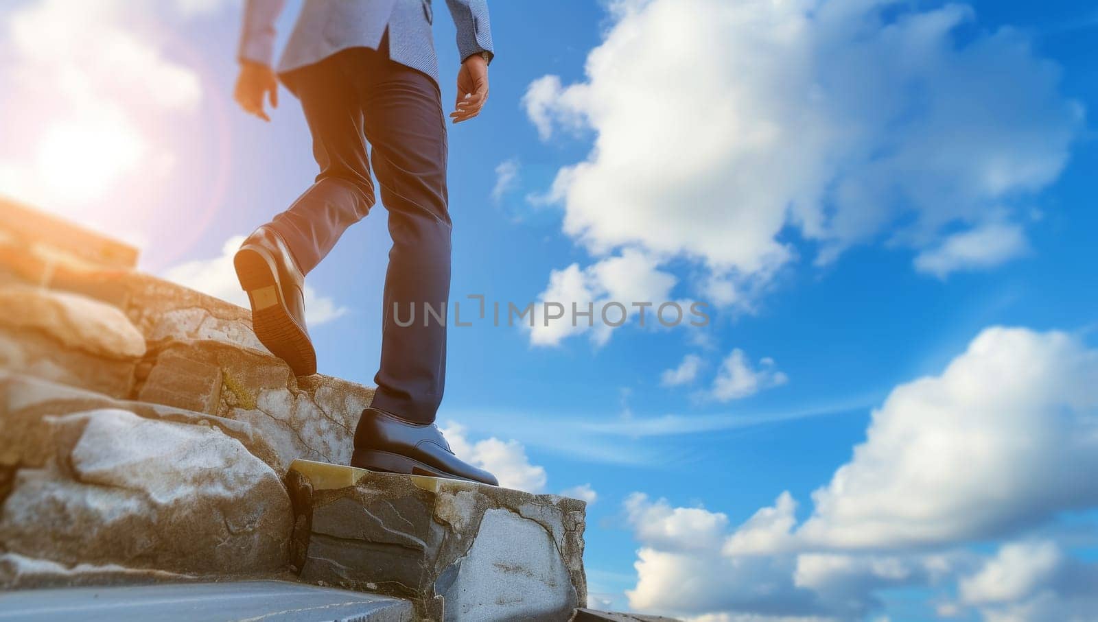Businessman standing on the top of a cliff with blue sky background