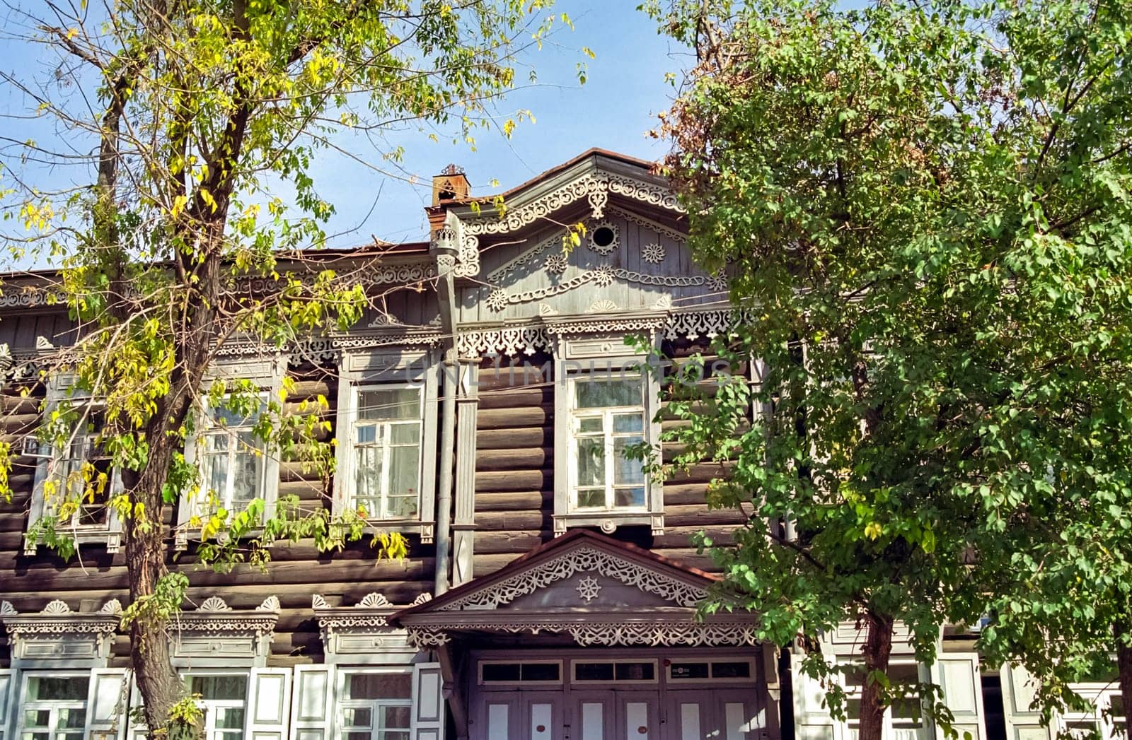 Plinths of windows of wooden houses. Ancient style of decoration of window frames.