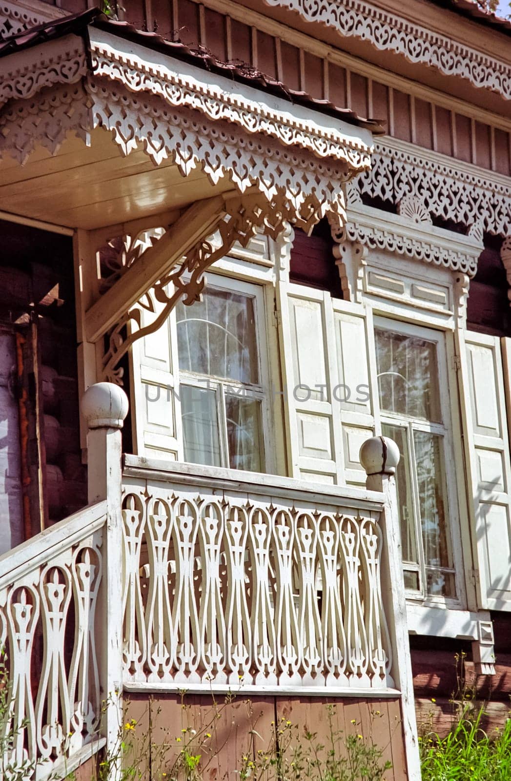 Plinths of windows of wooden houses. Ancient style of decoration of window frames.
