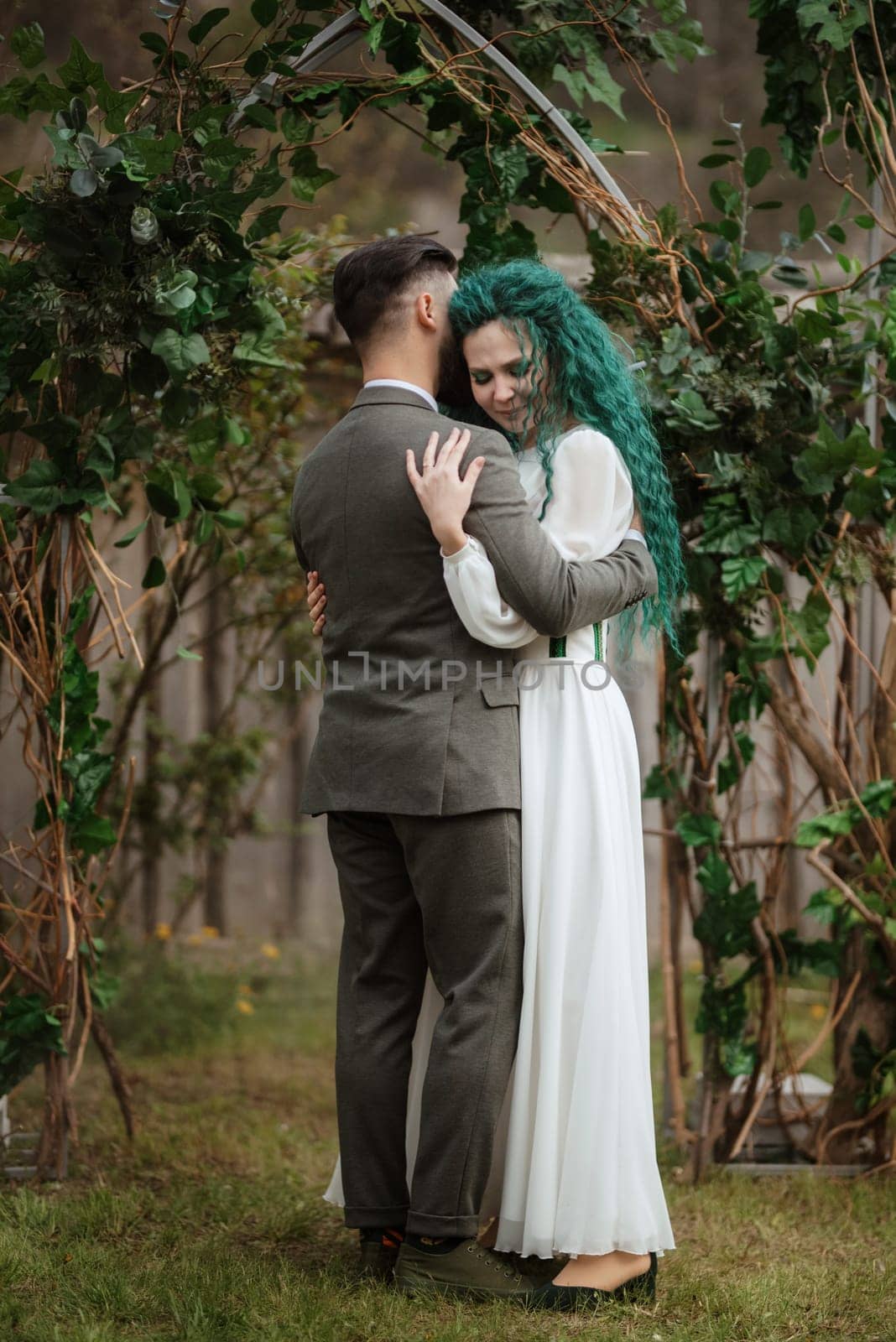 wedding ceremony of the newlyweds in a country cottage on a green hill