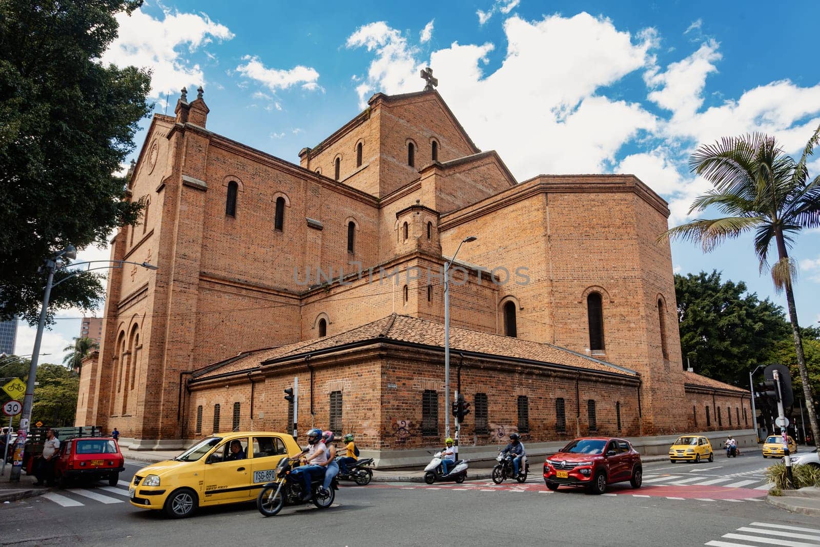 Medellin, Colombia - December 9, 2023: Street view capturing the essence of daily life behind Catedral Metropolitana de Medellin with people going about their routines. Antioquia department, Colombia.