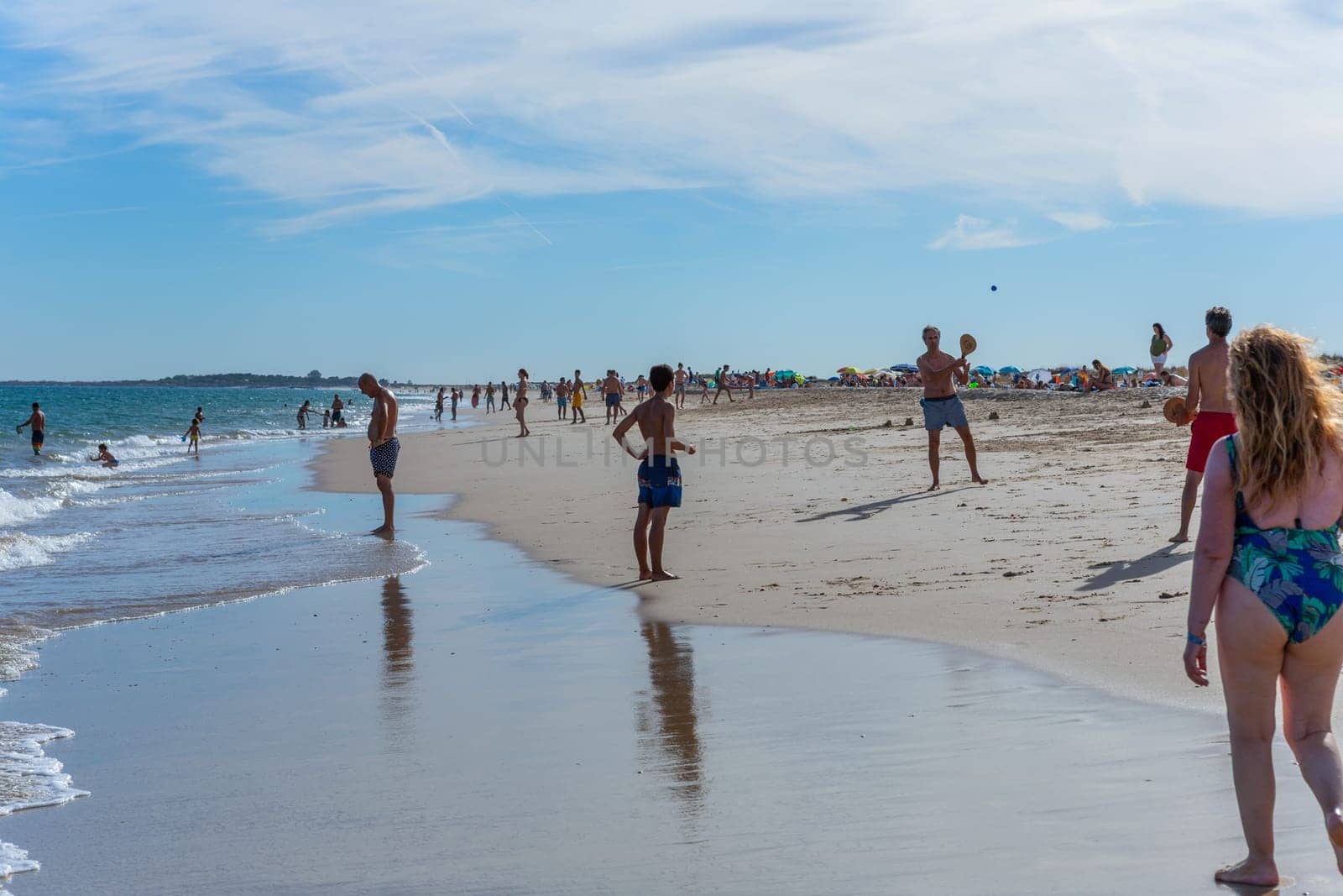 Tavira, Portugal - August 15, 2023: People at the famous beach of Tavira island in Tavira. This beach is a part of famous tourist region of Algarve.