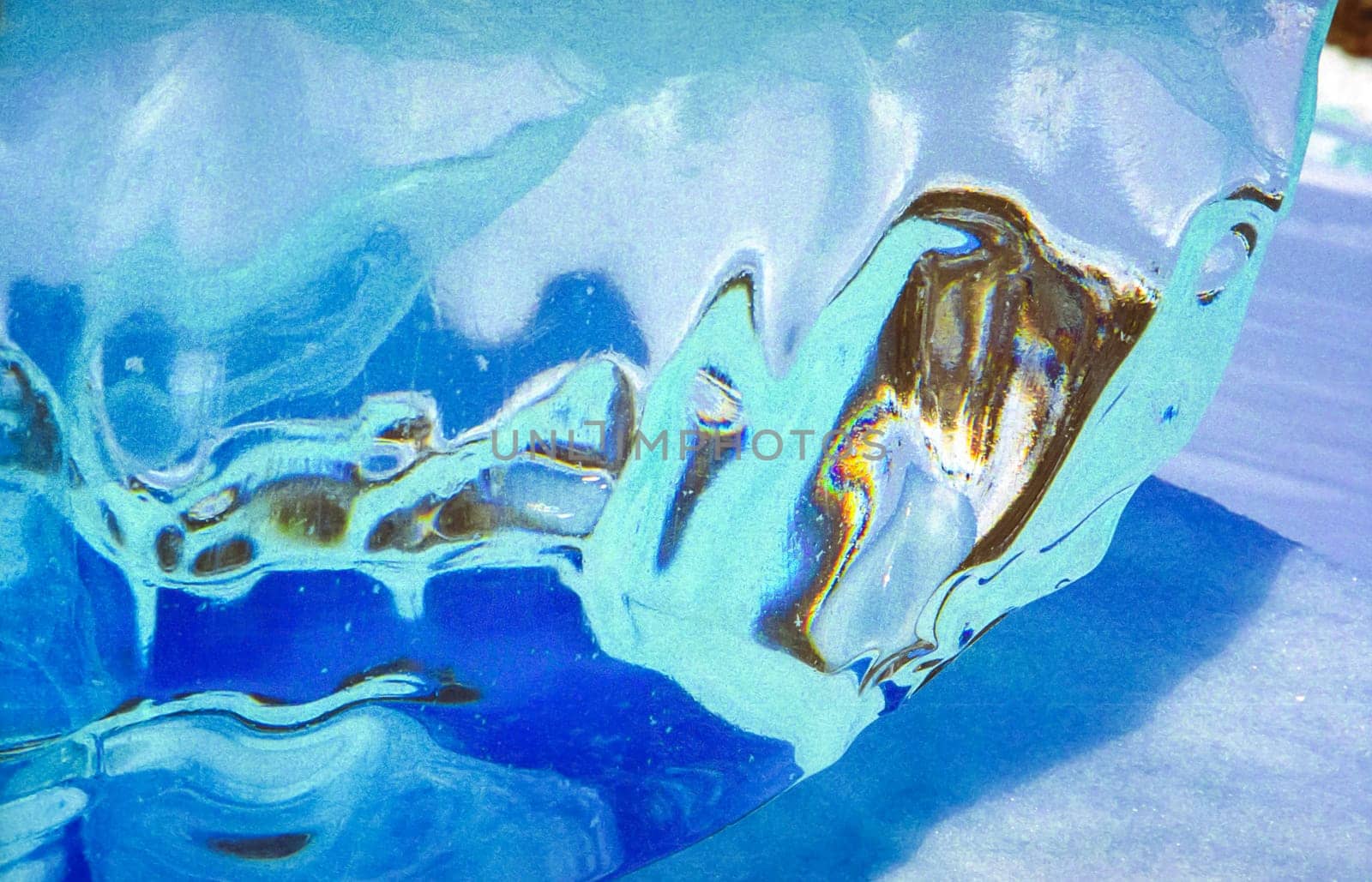 Frozen icicles of fresh water of lake Baikal. Winter on the Baikal, ice and snow on the lake. The beauty of the nature of Baikal in winter.