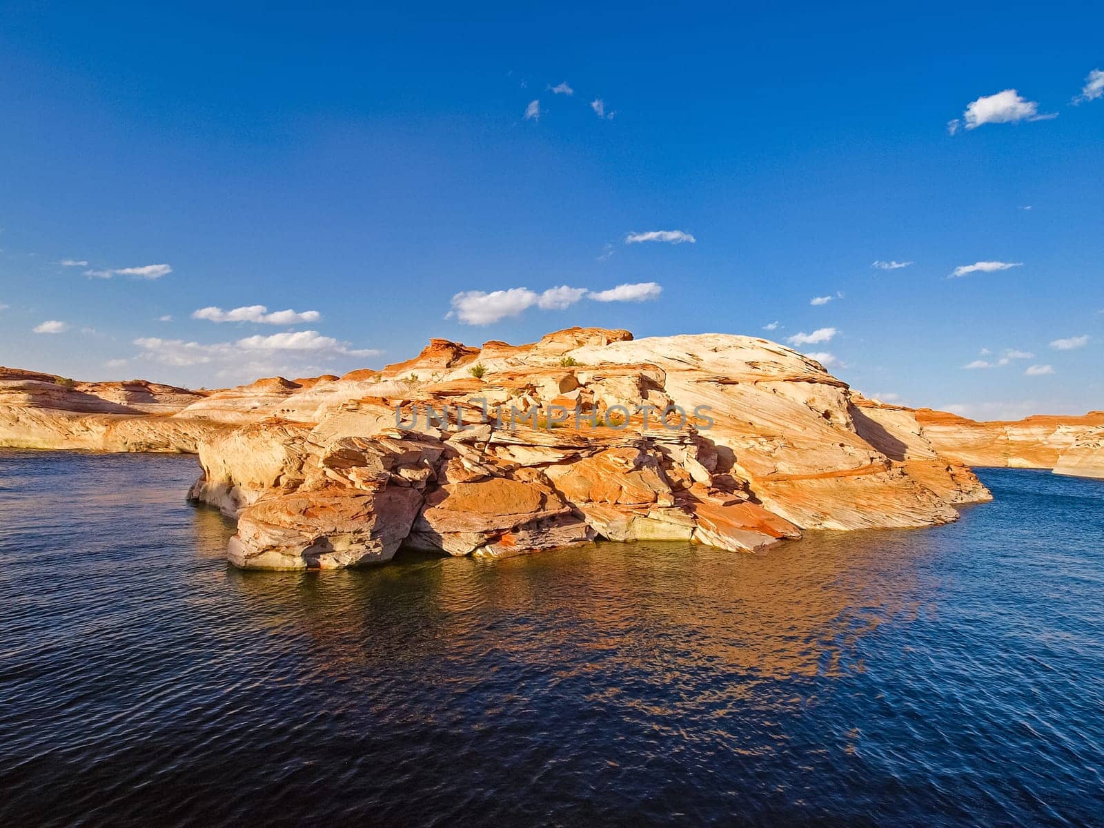 Lake Powell is based on Colorado River with a great view on the canyoon. Beautiful canyon and lonely rocks on the Lake Powell, Utah.