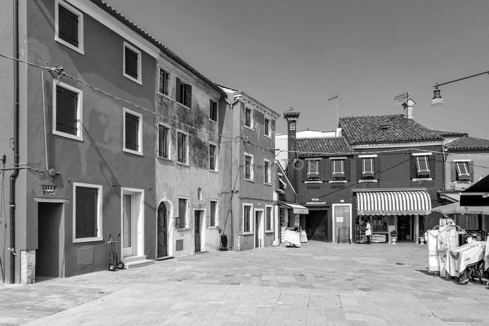 Burano, Italy - April 10, 2007: scenic historic town square in the village of Burano in different colors.