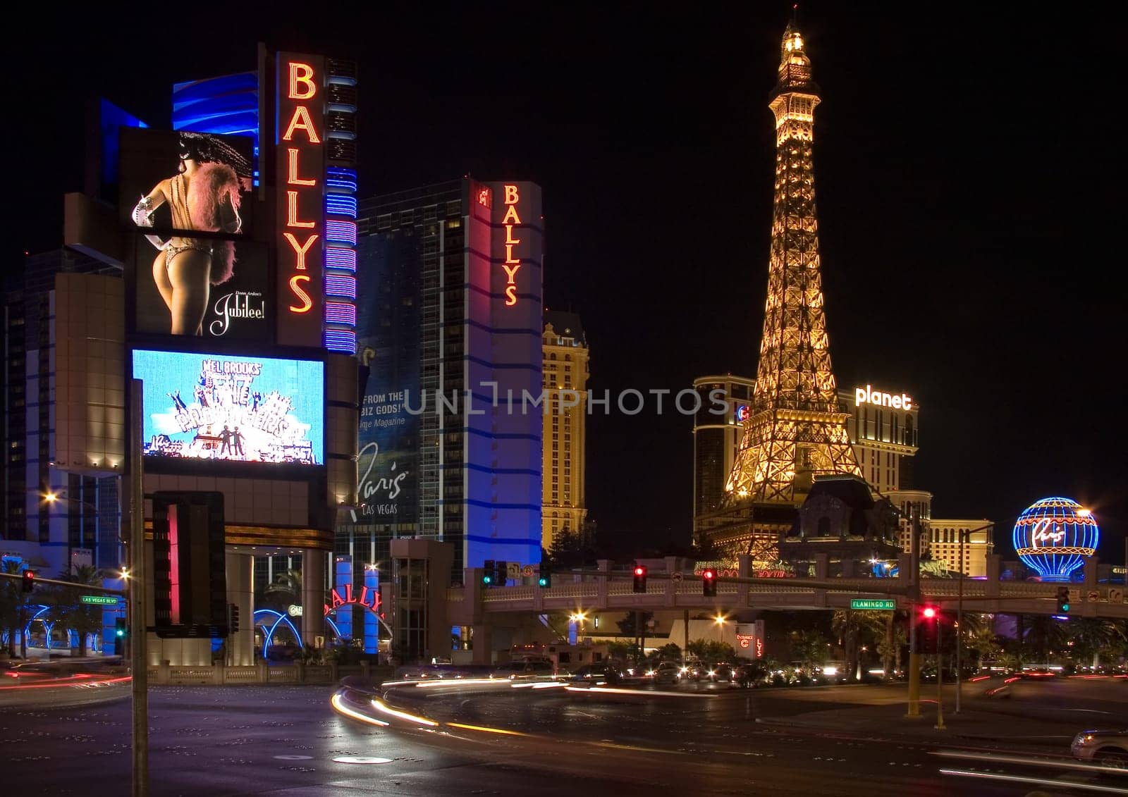 Las Vegas, USA - May 31, 2007: people enjoy the night view from the Strip to the Eiffel tower, Paris Paris and Ballys casino.