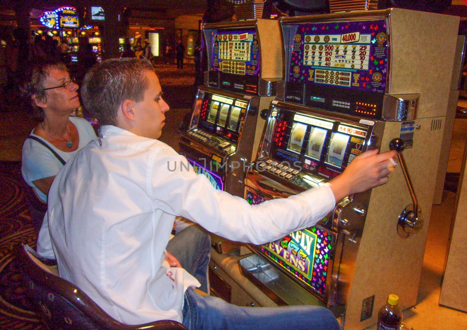 Las Vegas, USA - May 31, 2007: people enjoy playing at the slot machine in Las Vegas, USA.