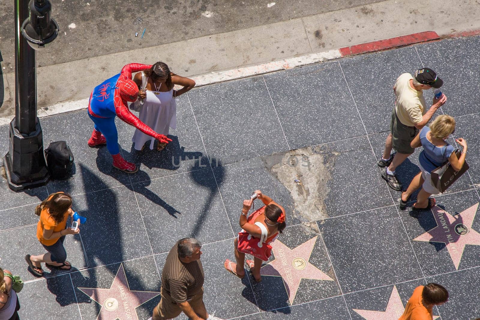 Los Angeles, USA - July 5, 2008: people in costumes like spiderman offer a picture with tourists for a tip in Hollywood at the walk of fame.