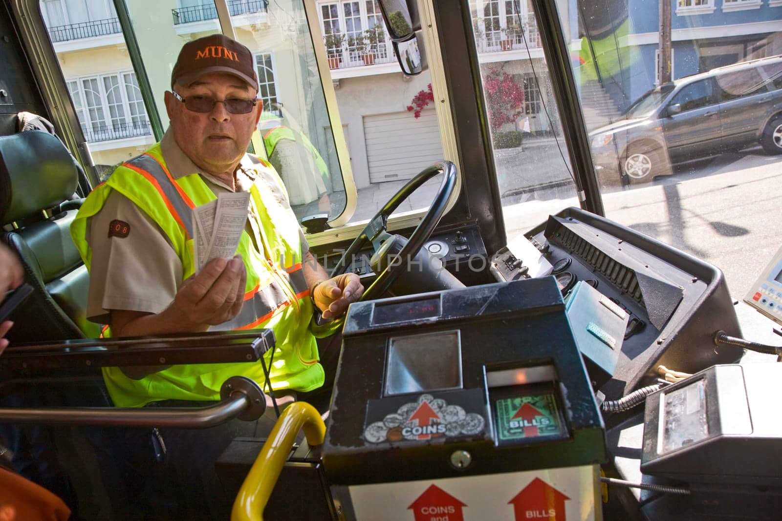 San Francisco, USA - July 24, 2008: bus driver sells bus tickets and hands over the tickets after payment.