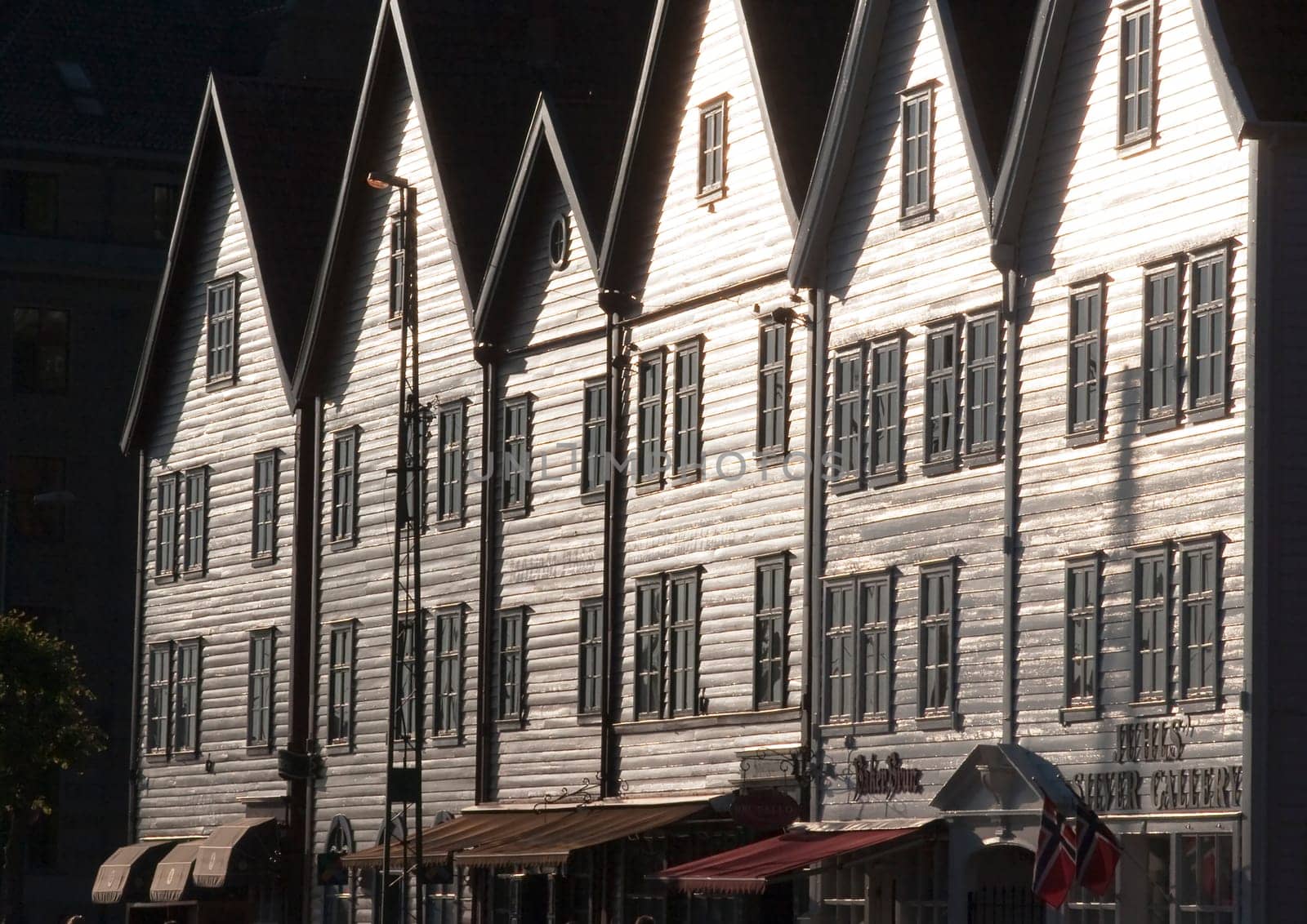 Bergen, Norway - July 3, 2009: Famous Bryggen street with wooden colored houses in Bergen, Norway, UNESCO world heritage site