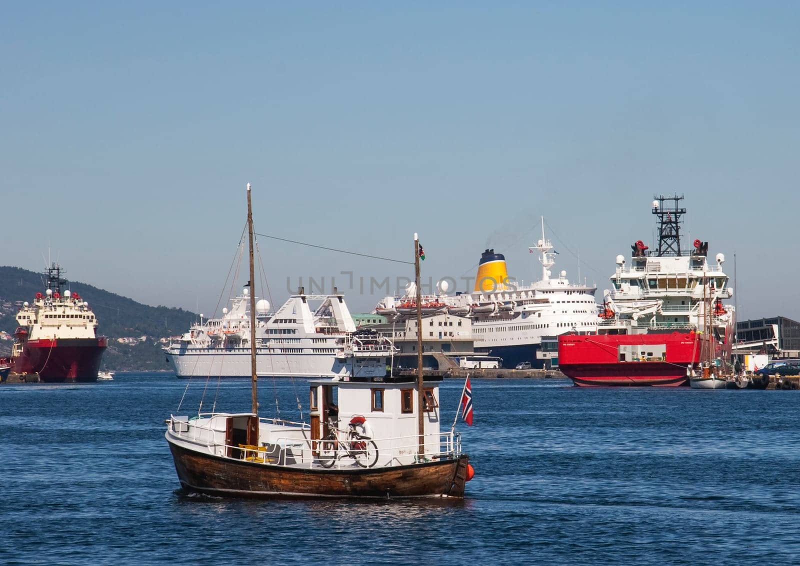 Bergen, Norway - July 4, 2009: ferry and old fishermans boat in the harbor of  Bergen, Norway, UNESCO world heritage site